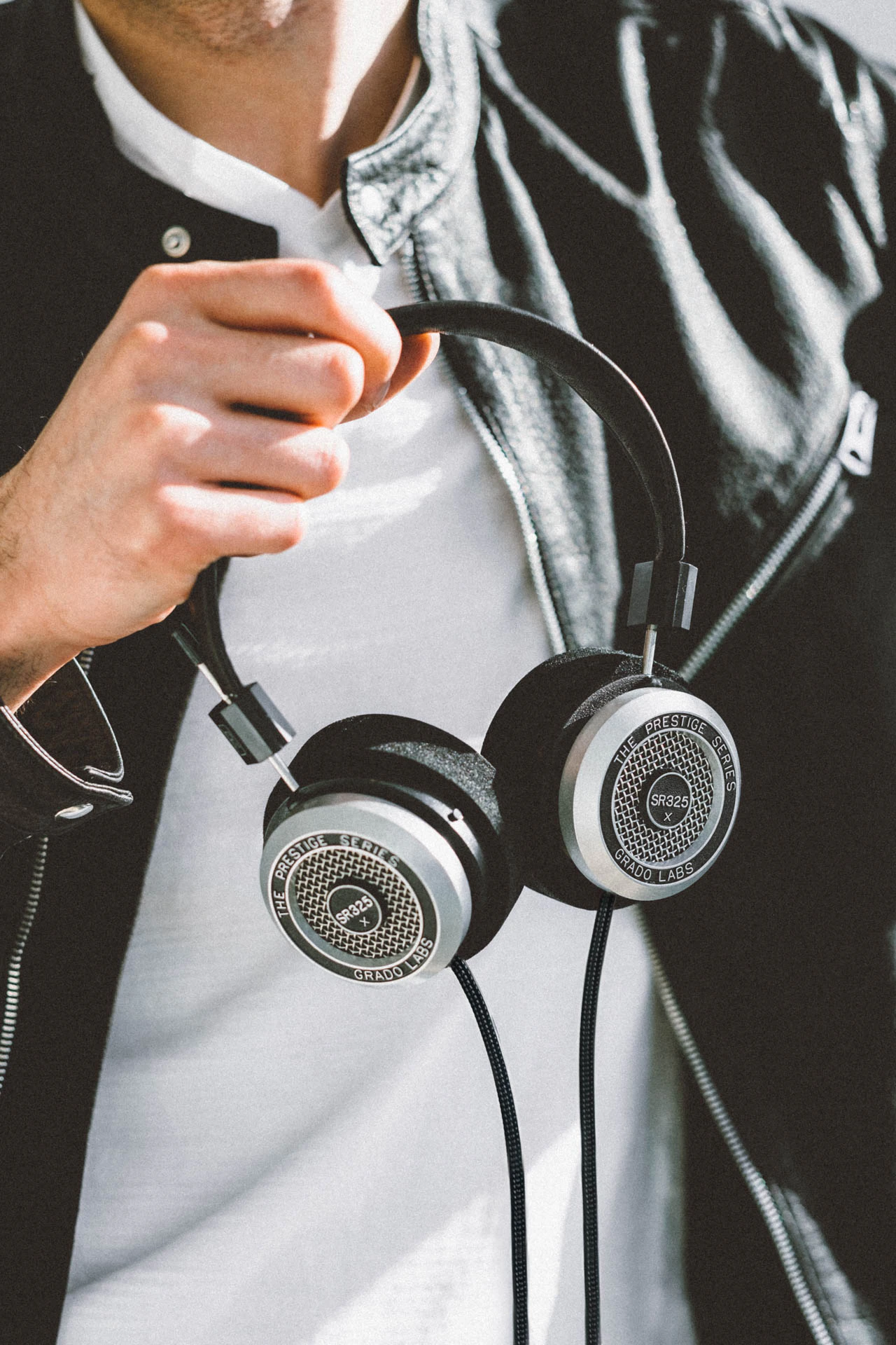 Grado SR325e headphones being held