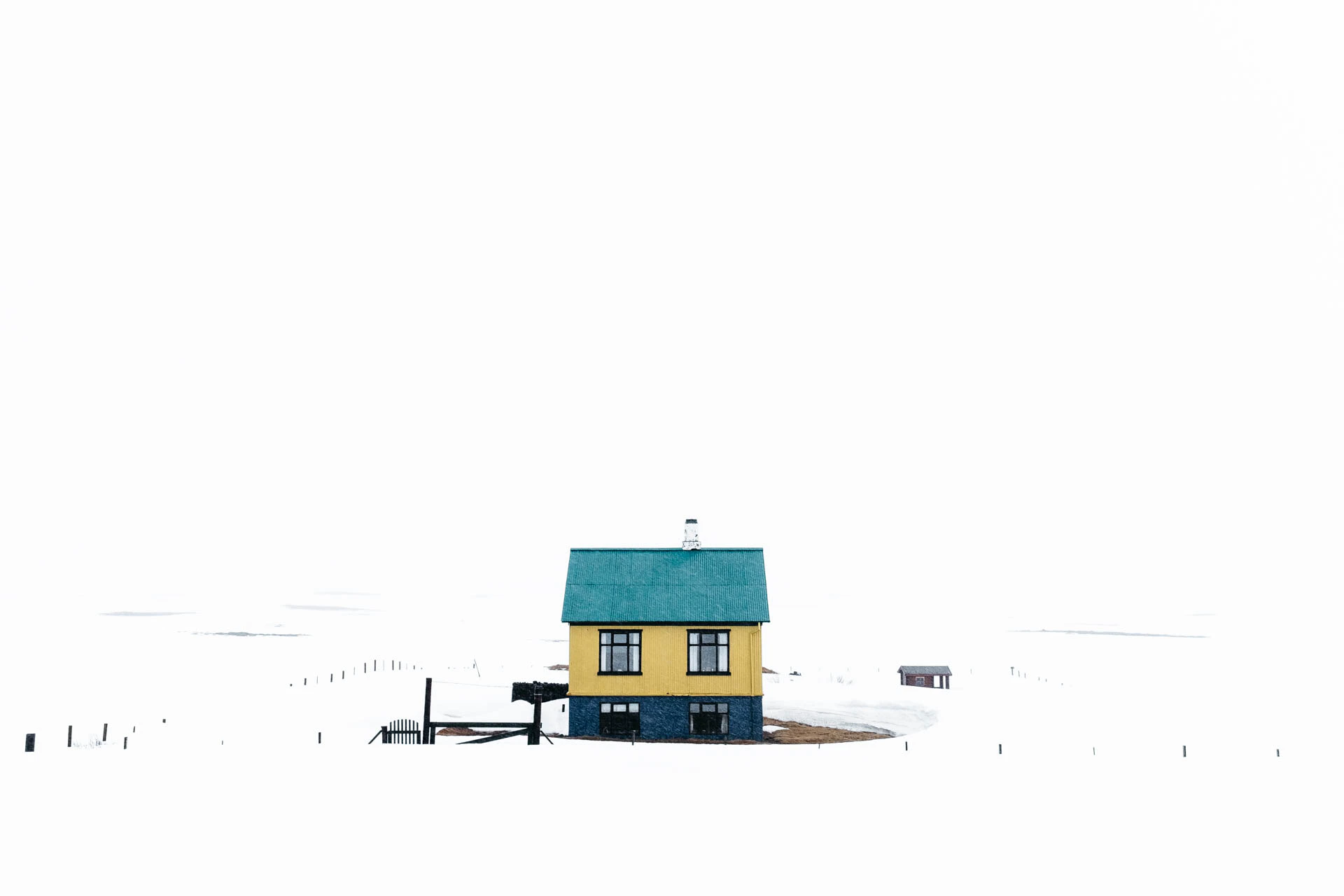 Yellow and green house in snow in Iceland