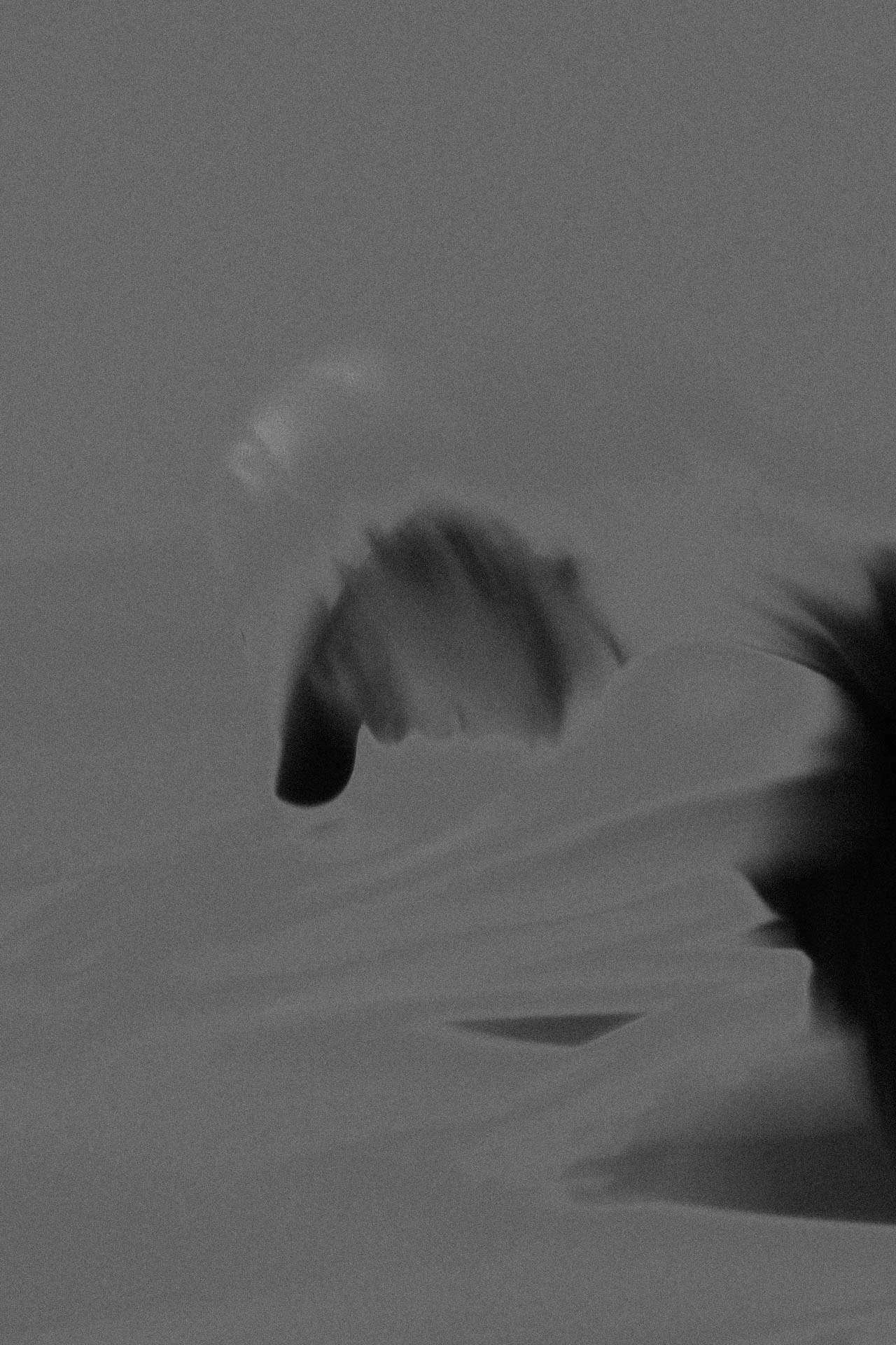 Faceless man looking down in black and white grain. He's Right There from Jonathan Grado's Dirty Static.