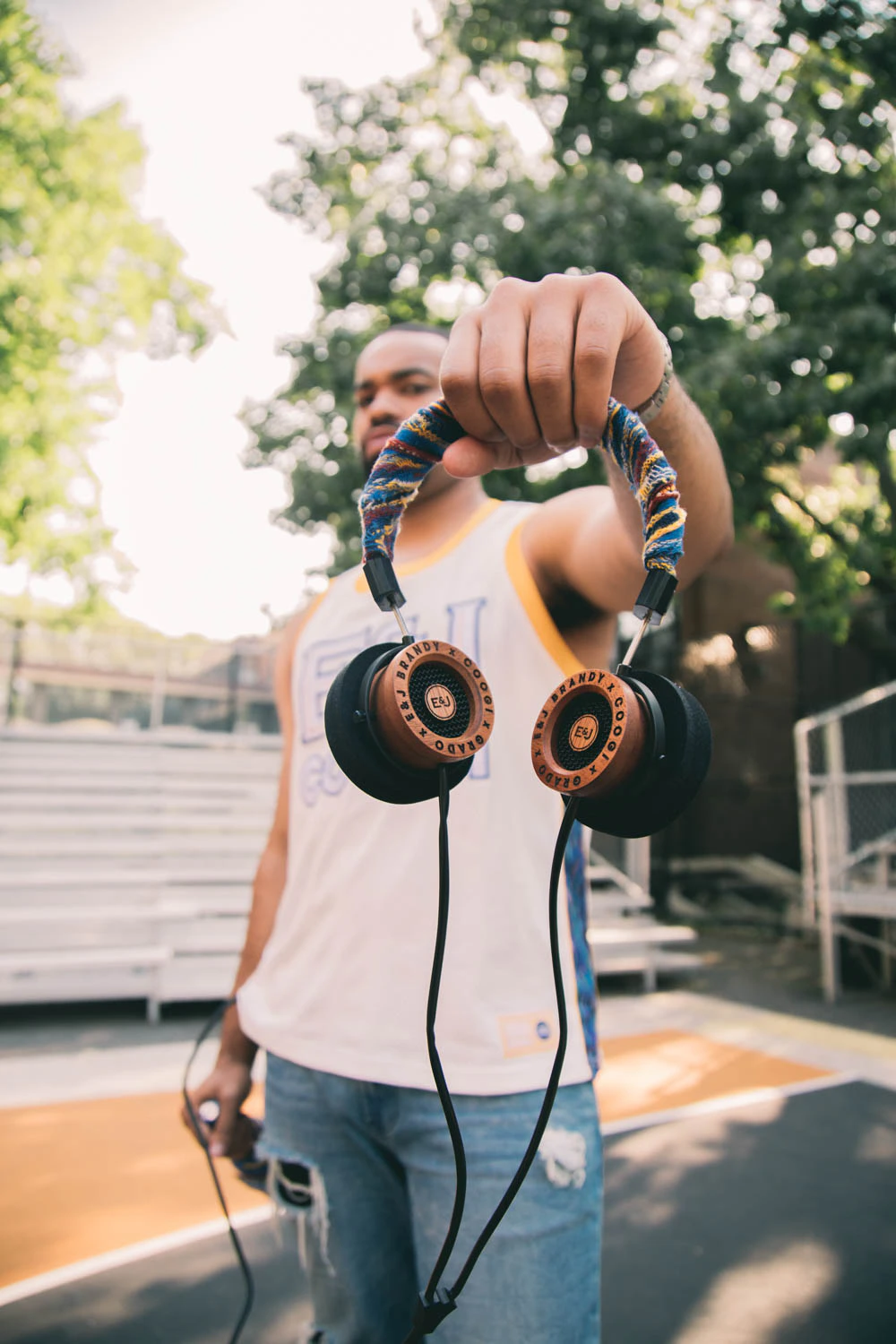 man holding Grado Labs x Coogi x EJ headphones
