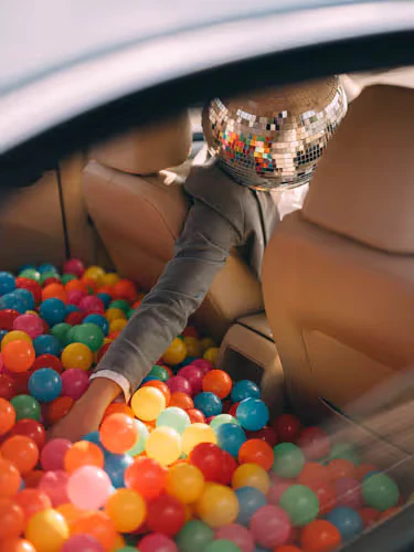 Disco head man in a car from Happy Hour