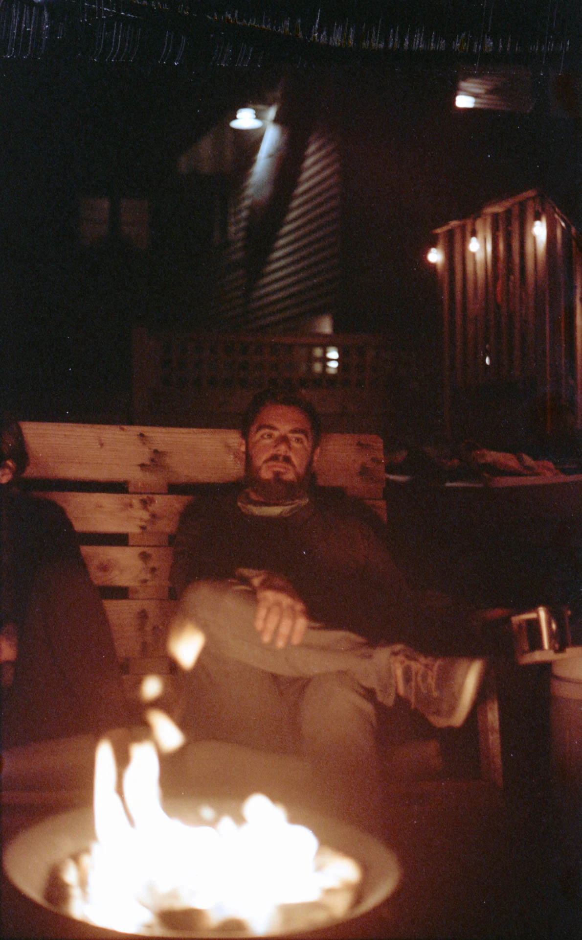 a man by a campfire on film