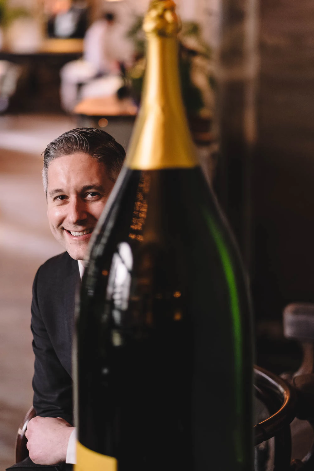 Beverage director of Le Coucou Charles Puglia with Drappier champagne bottle