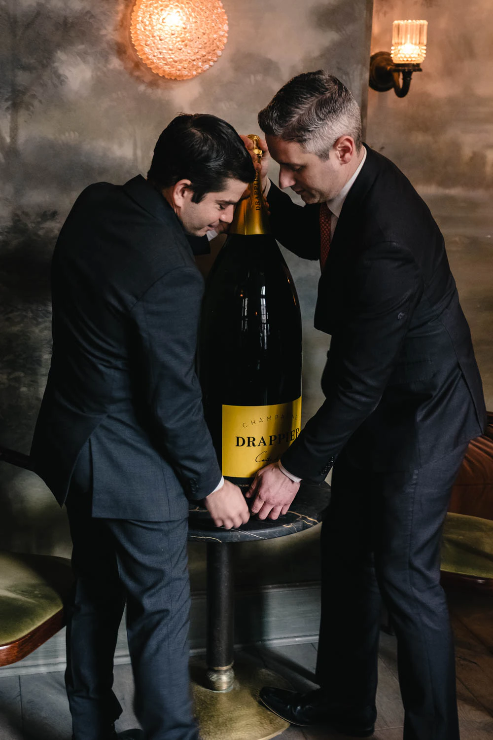 Beverage director of Le Coucou Charles Puglia with Drappier champagne bottle