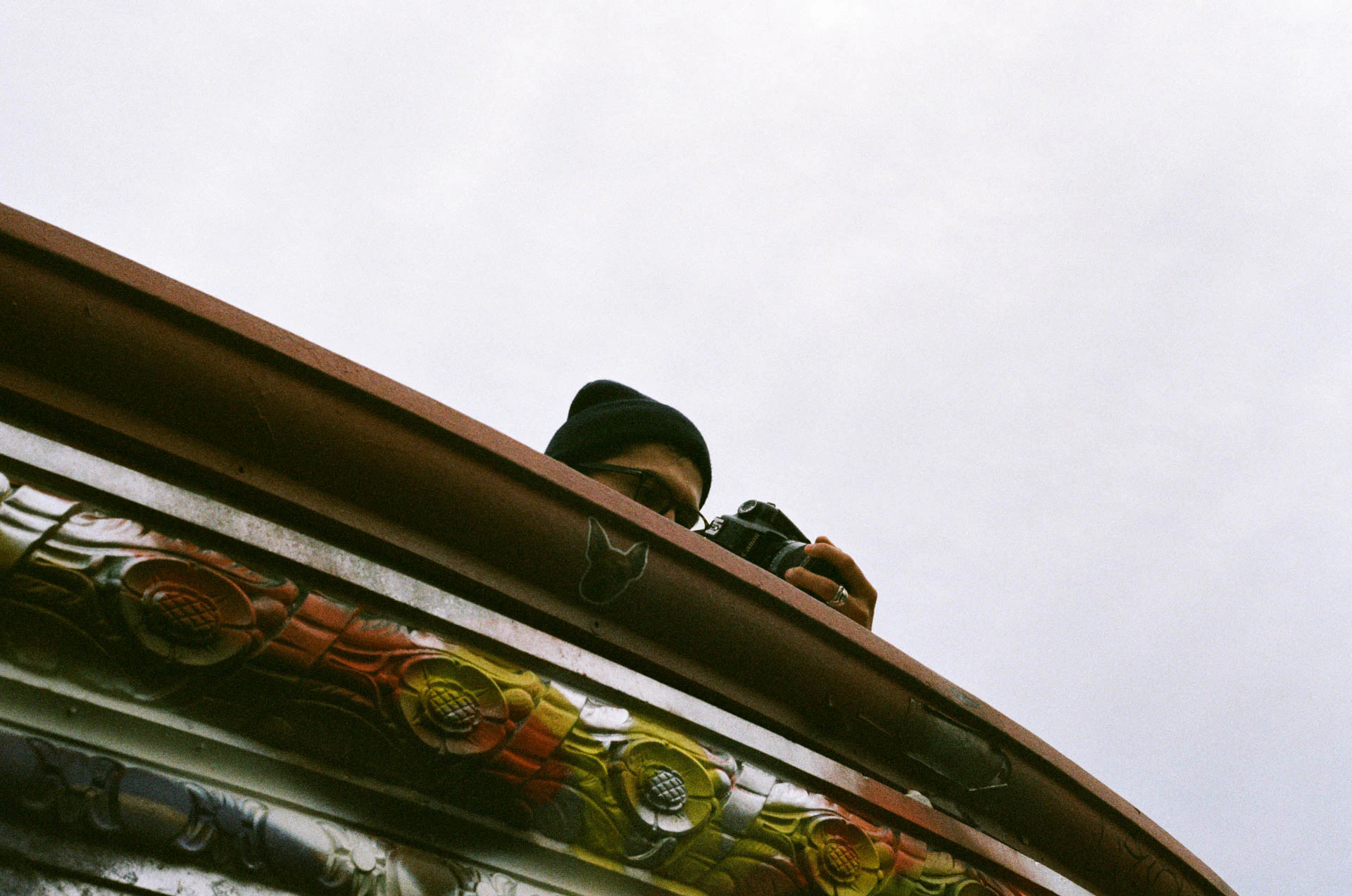 man photographing Williamsburg bridge on film