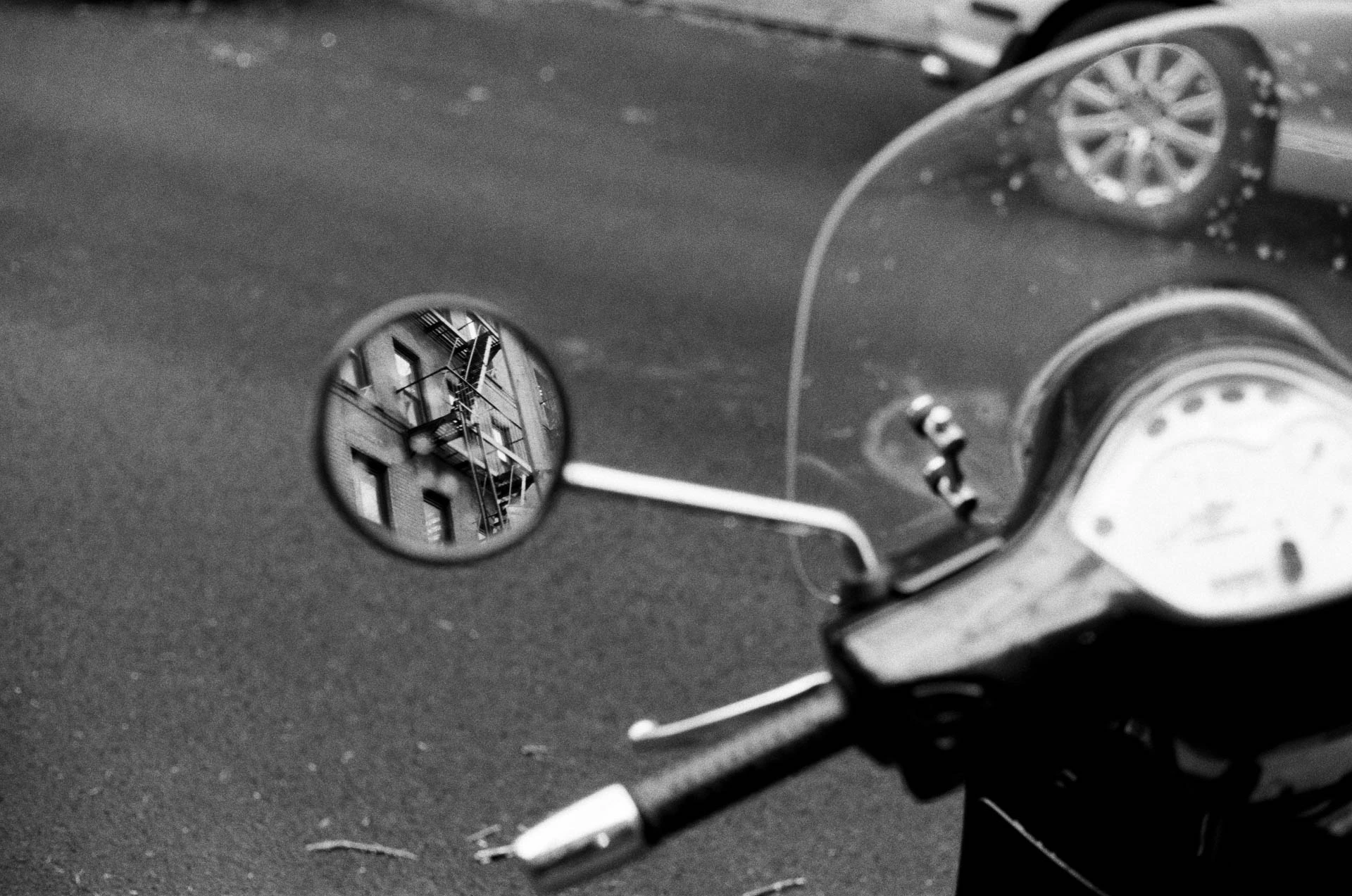Brooklyn brownstone in motorcycle mirror on film