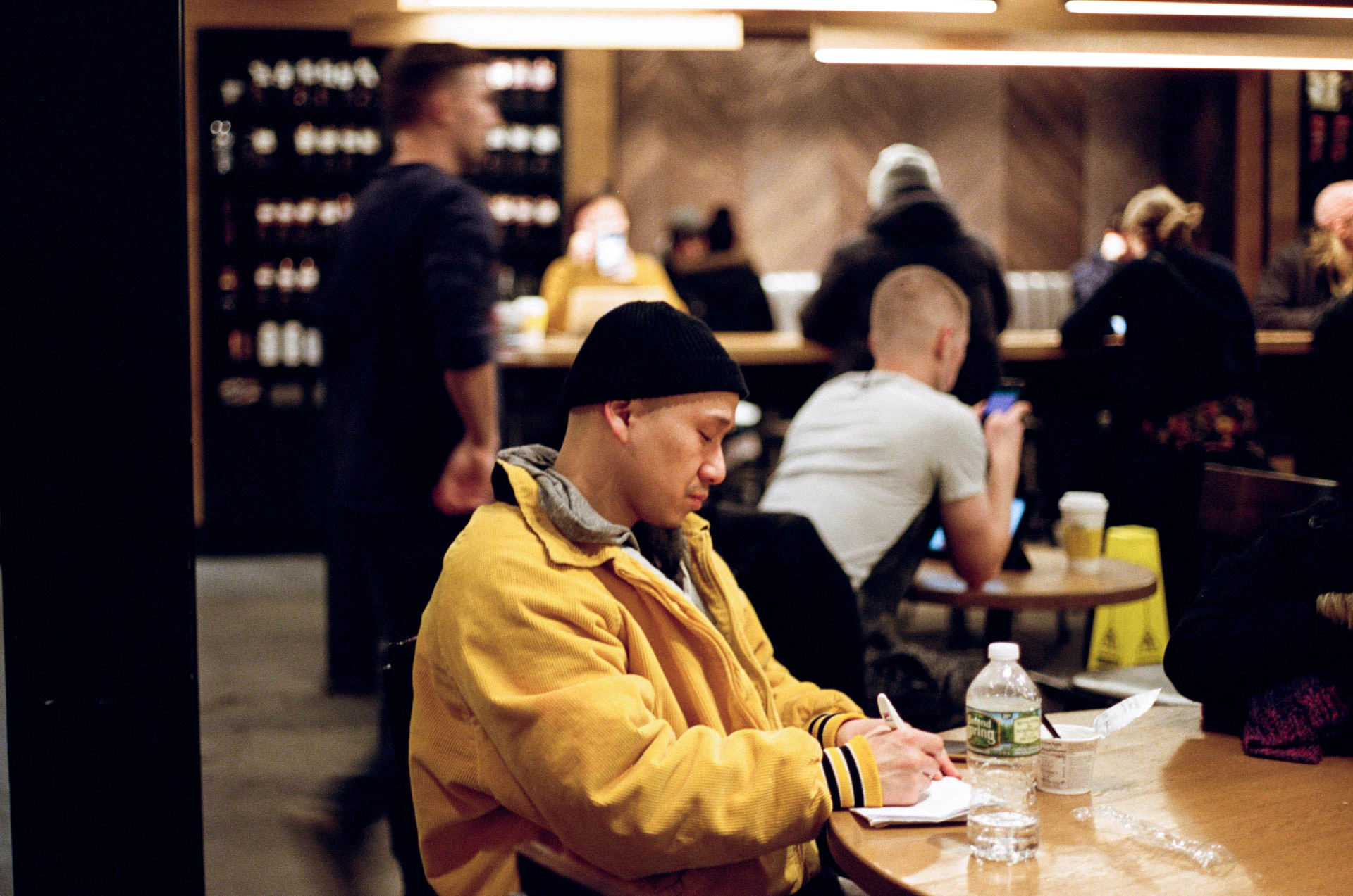 man in yellow jacket at starbucks on film