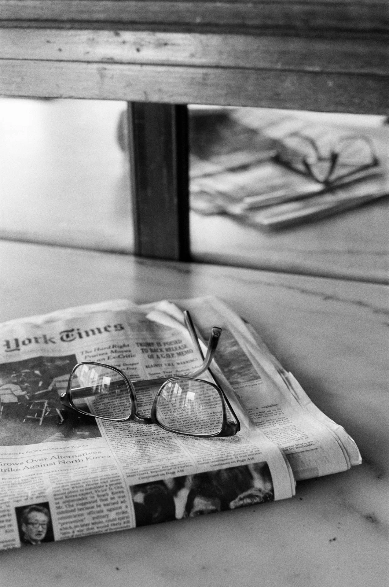 newspaper and glasses at coffee shop on film