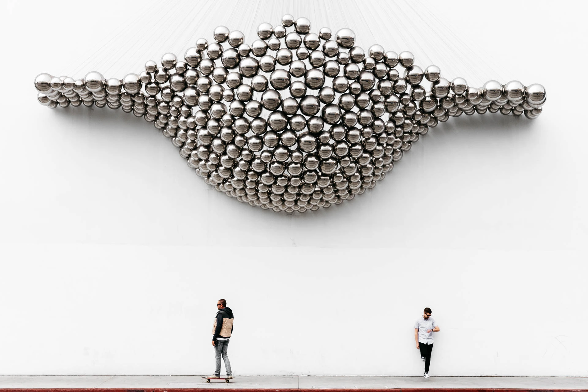 skateboarder under Santa Monica marble wall