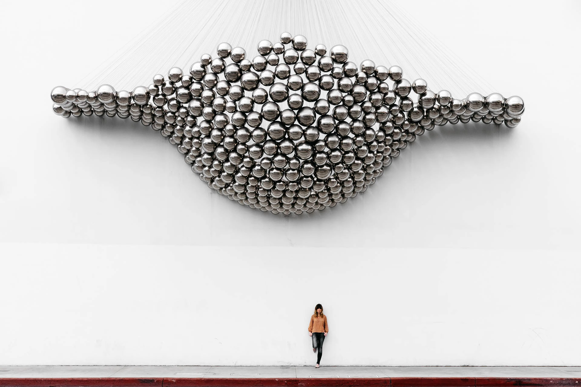 woman under Santa Monica marble wall
