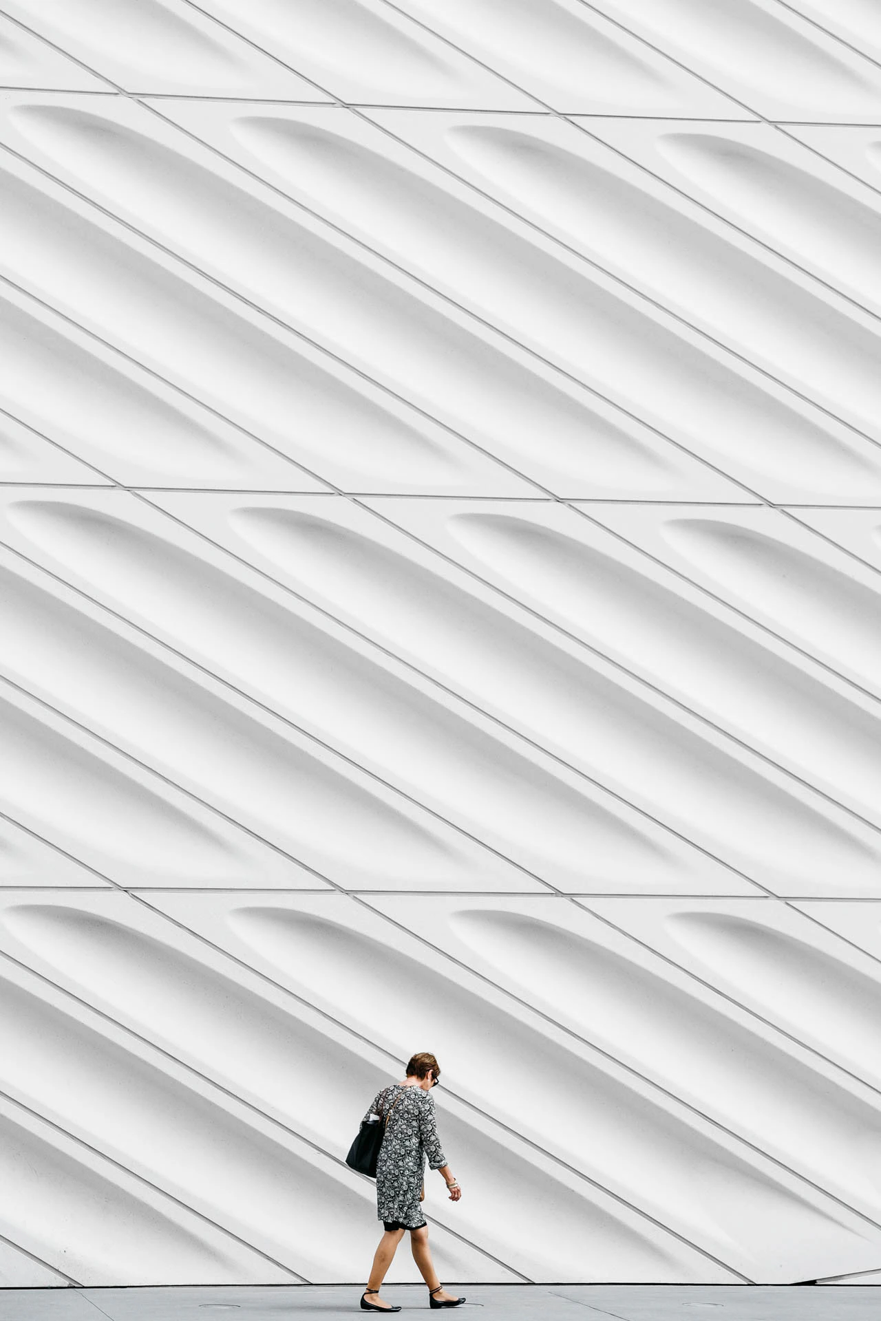 woman walking in front of the broad museum exterior in los Angeles