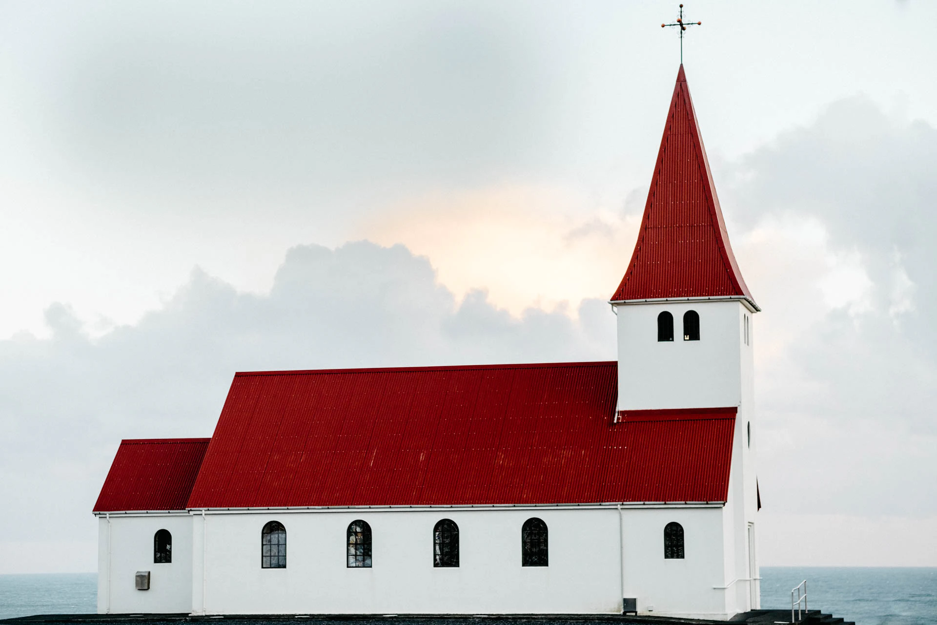 red and white church in iceland