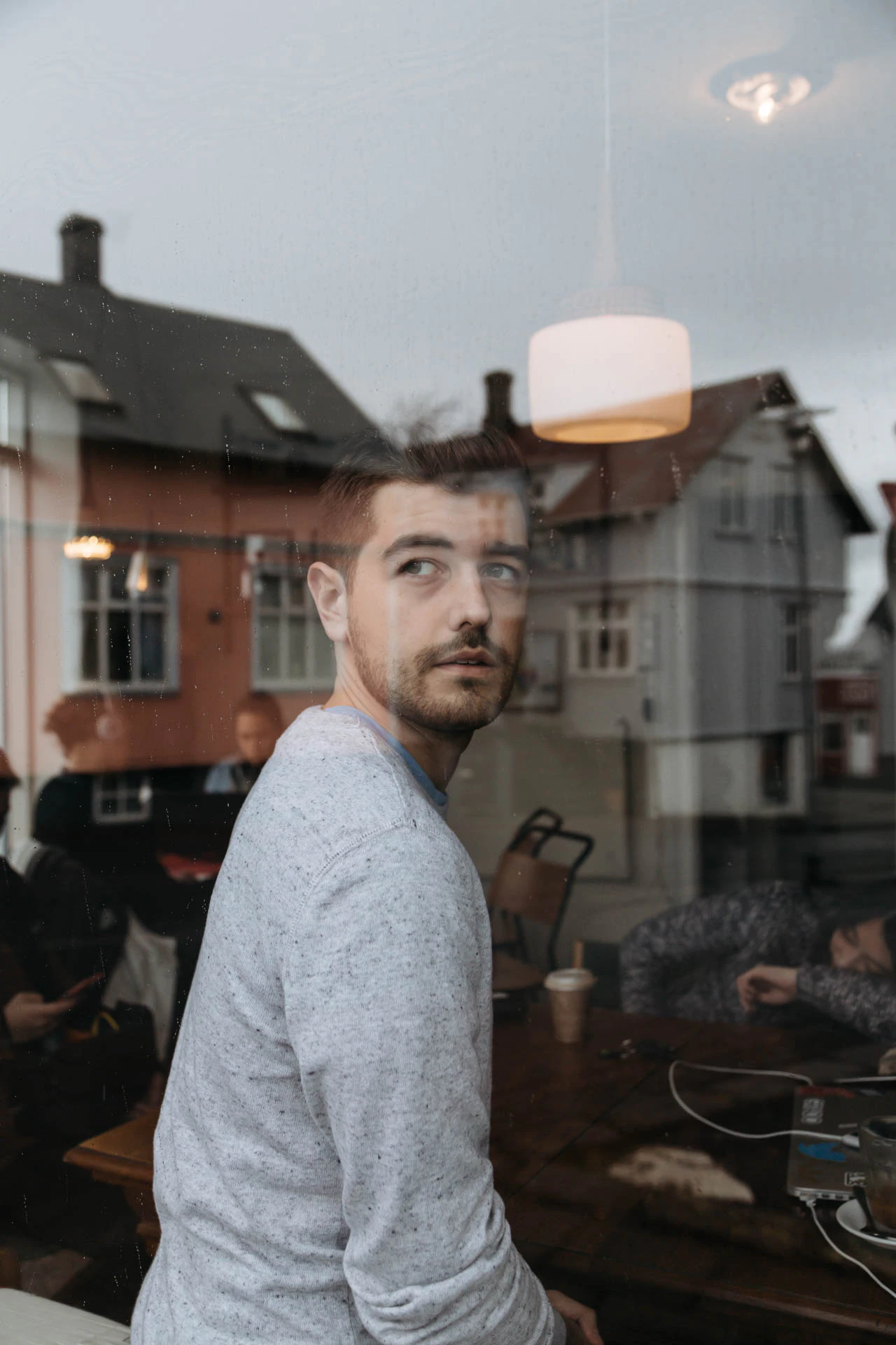 Jonathan Grado portrait in a coffee shop window