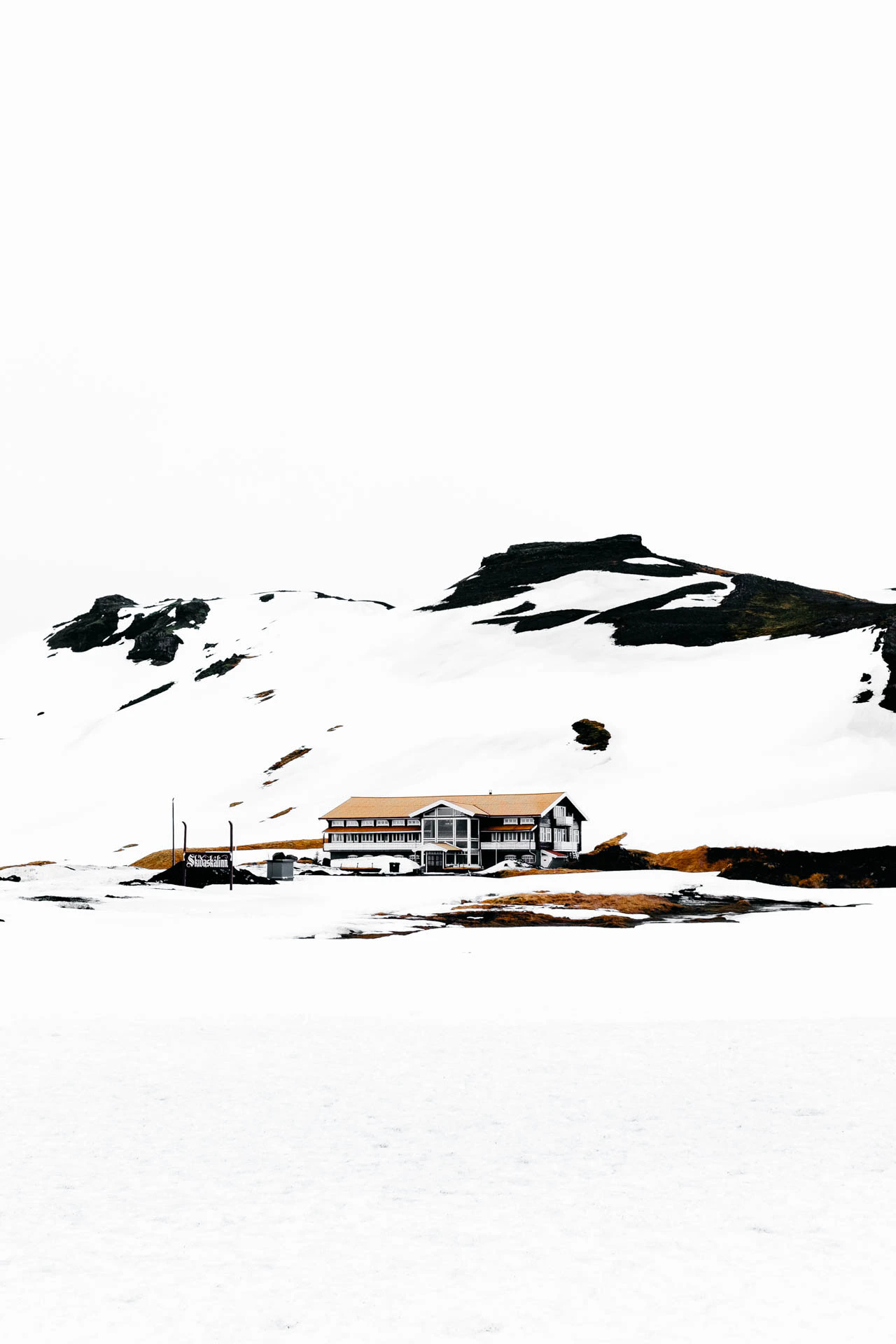 snowy mountain house near hot springs in iceland