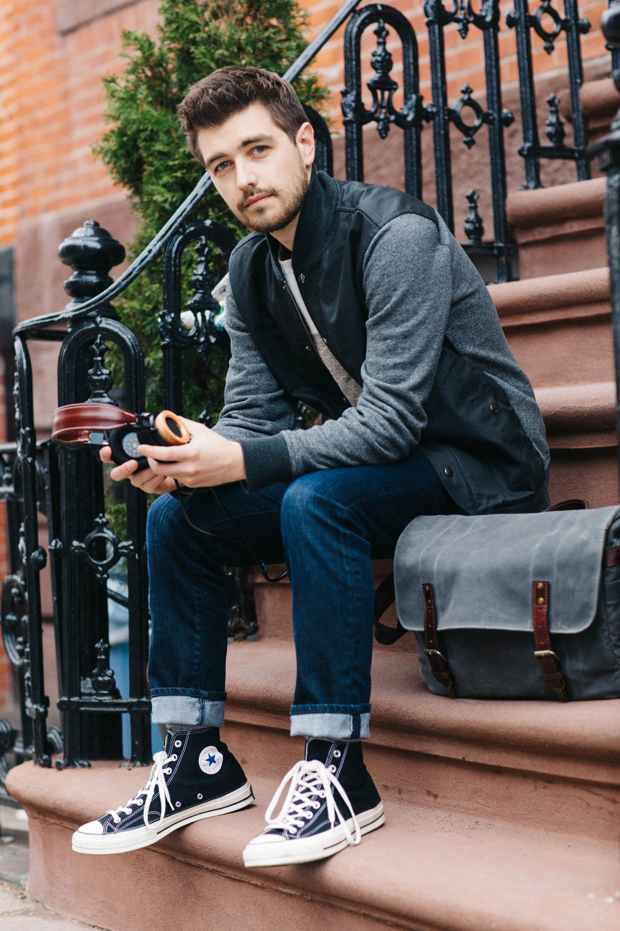 Jonathan Grado with ONA photo bag on stoop