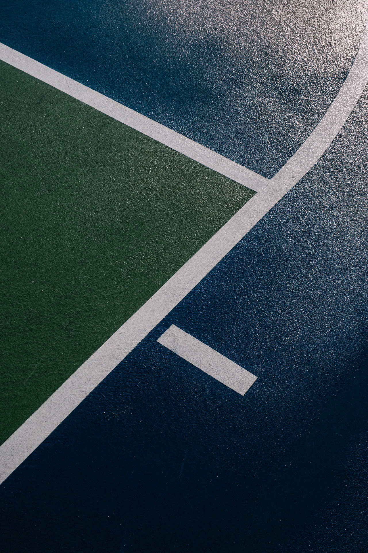 abstract lines of a green and blue basketball court after rain