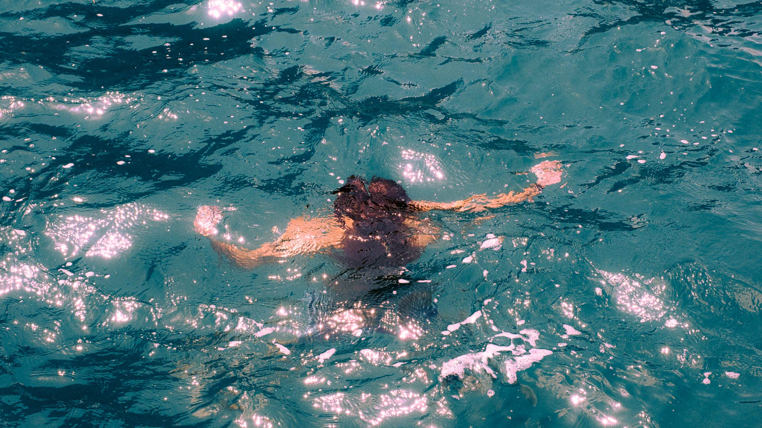 man swimming in the ocean in Sicily