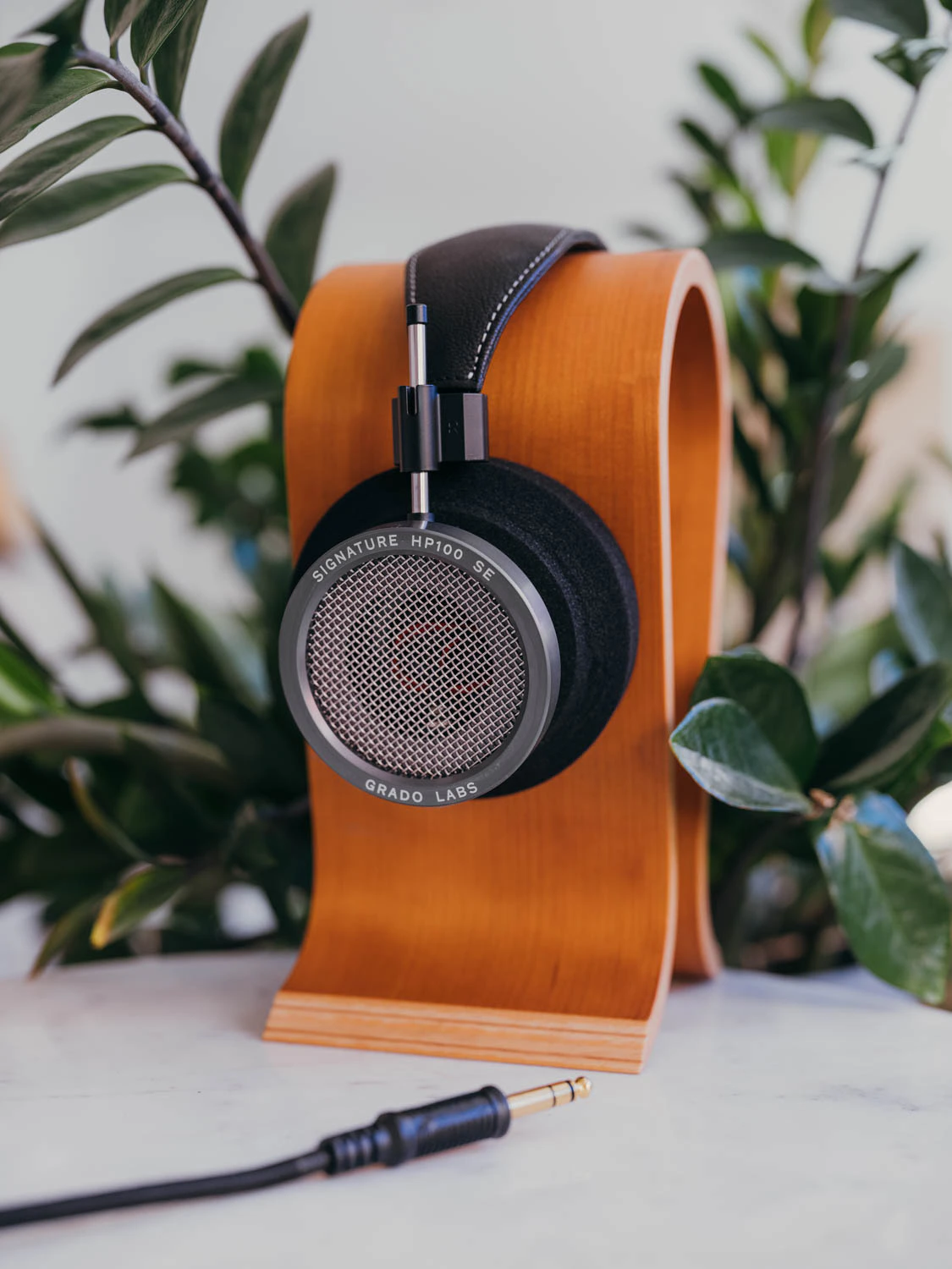 Grado HP100 SE headphones shot on Fujifilm gfx100s ii with plants and headphone stand