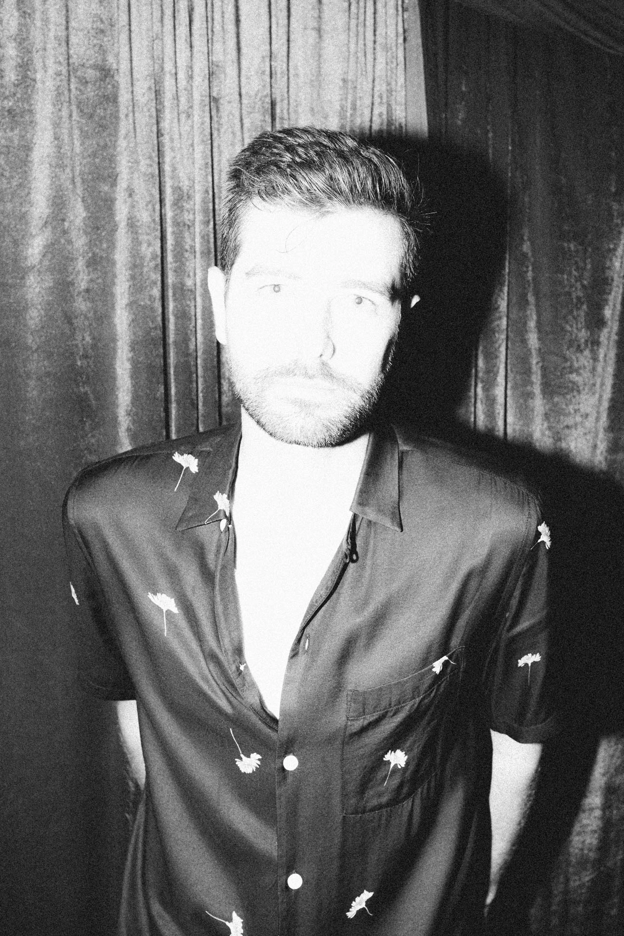 Portrait of Jonathan Grado overexposed using heightened look flash photography. Black and white velvet.