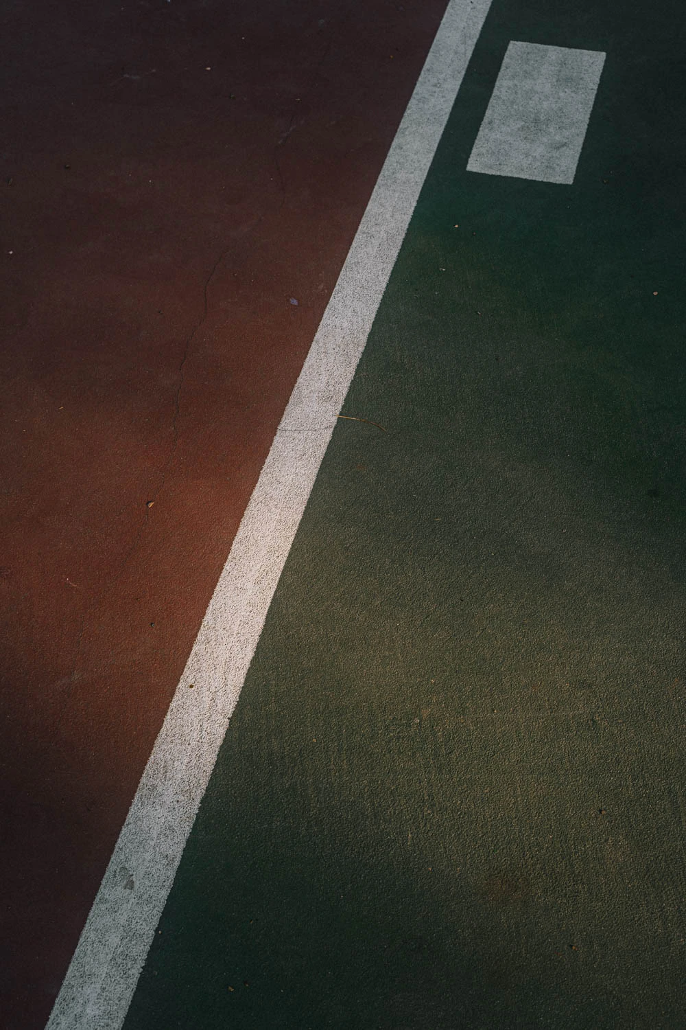 abstract green and red basketball court lines at sunset