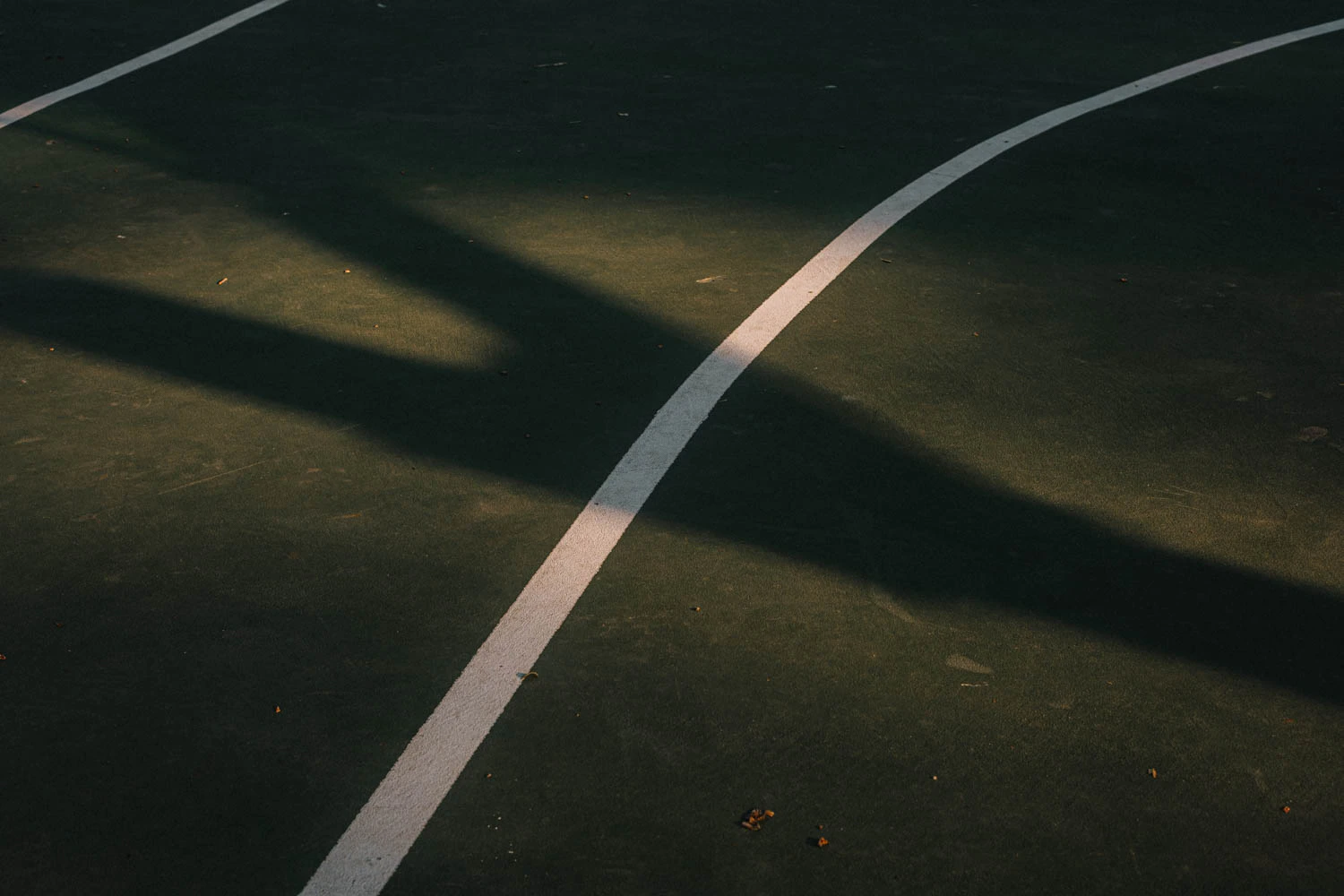 abstract green and red basketball court lines at sunset
