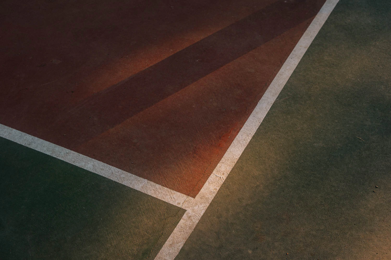 abstract green and red basketball court lines at sunset