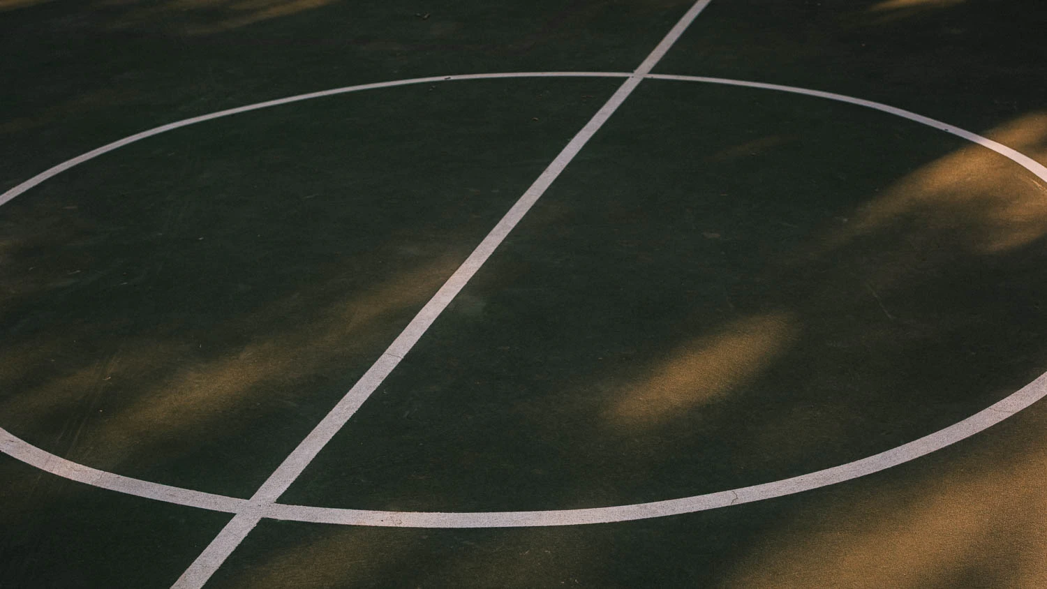 abstract green and red basketball court center circle at sunset