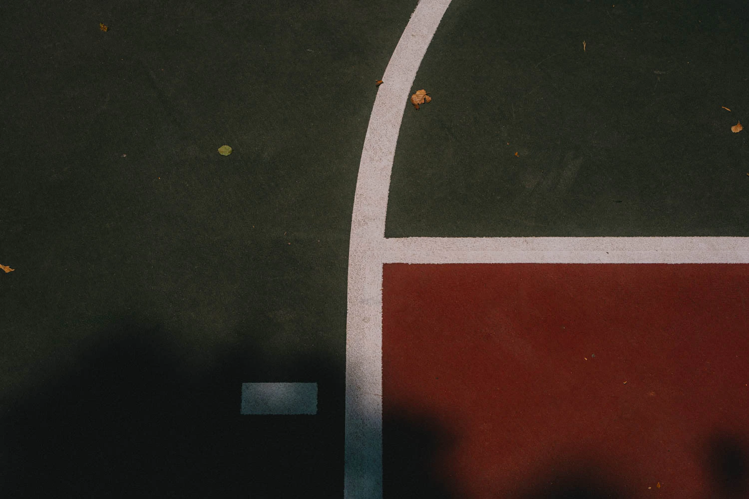 abstract green and red basketball court lines at sunset