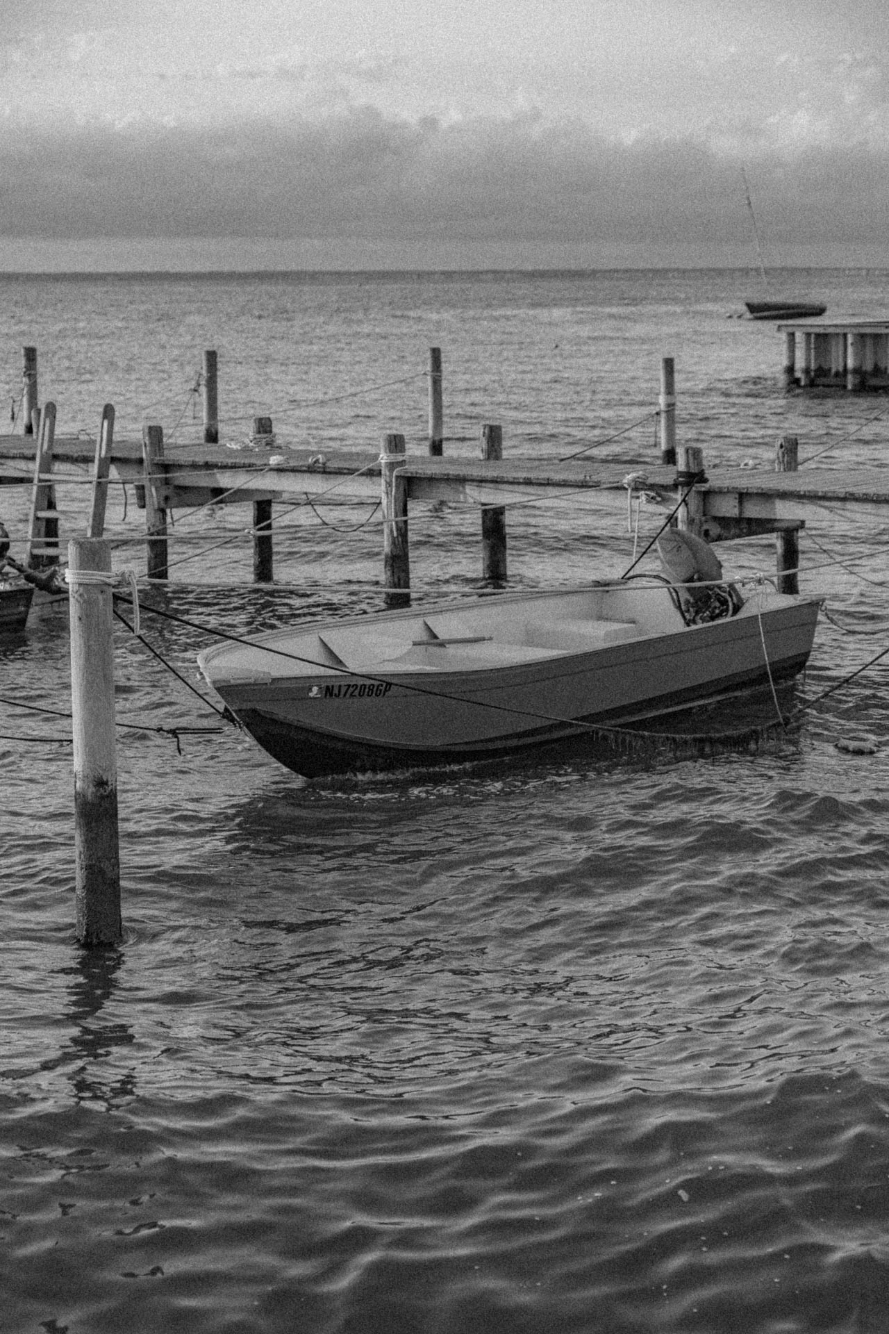 boat on a bay in black and white