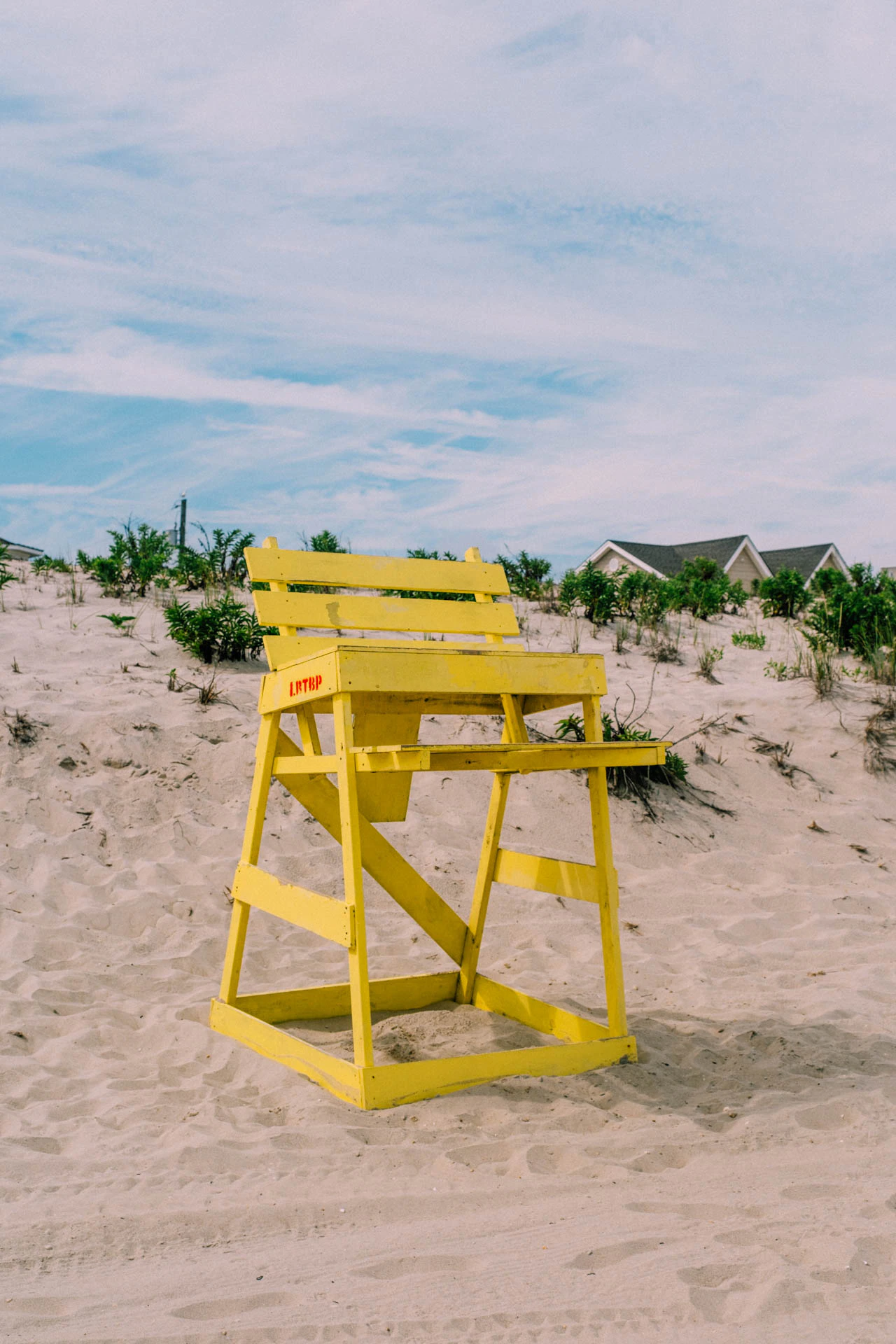 yellow lifeguard chair in beach haven