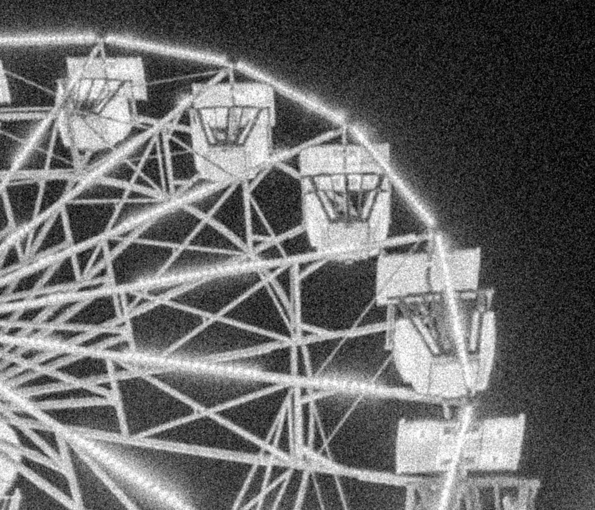 very grainy ferris wheel in black and white