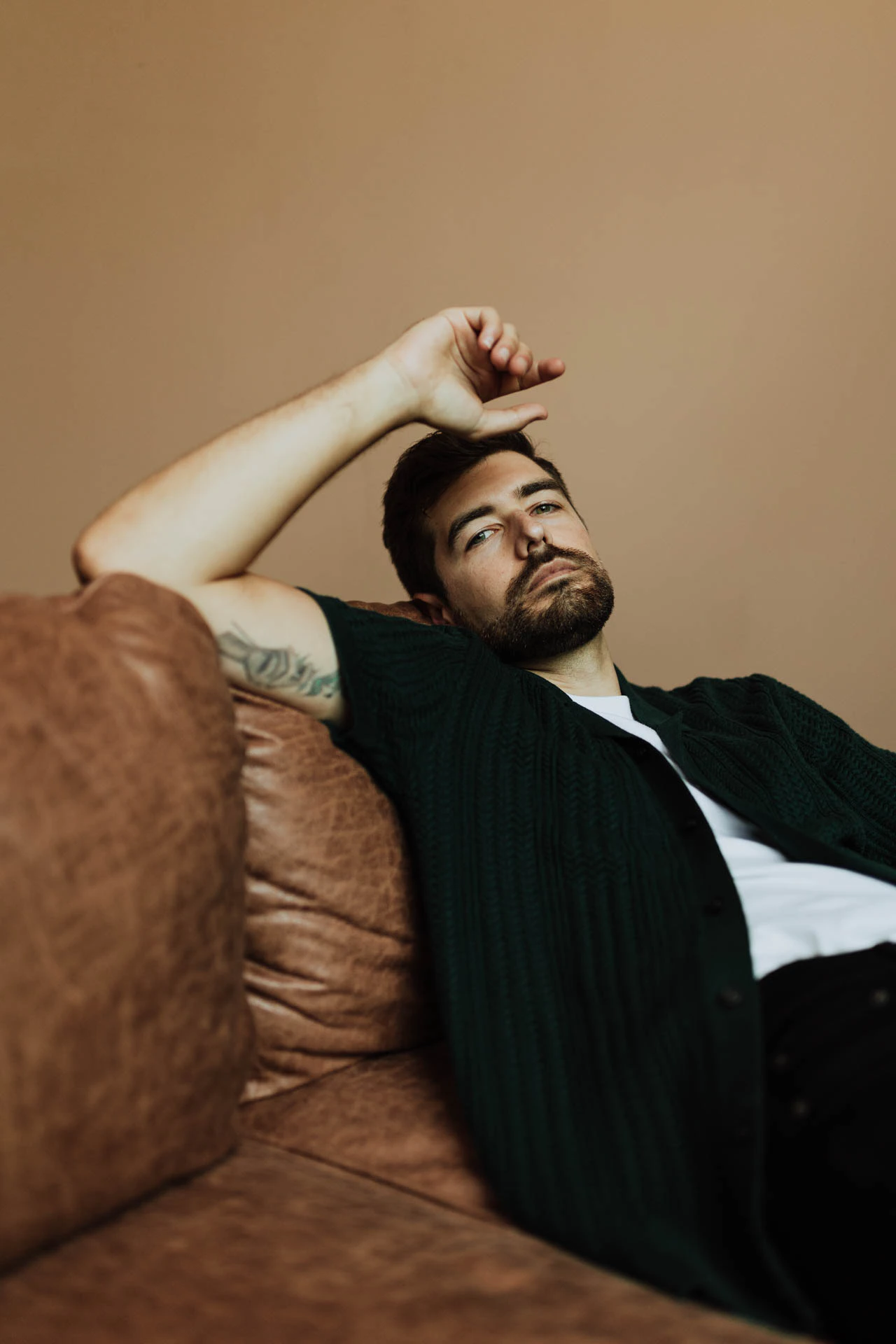 portrait of Jonathan Grado sitting on a couch