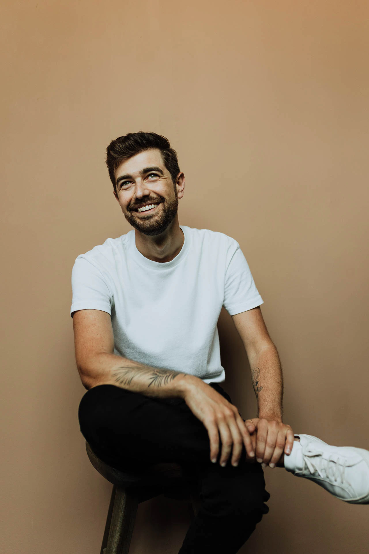 Jonathan Grado sitting in a white shirt and smiling