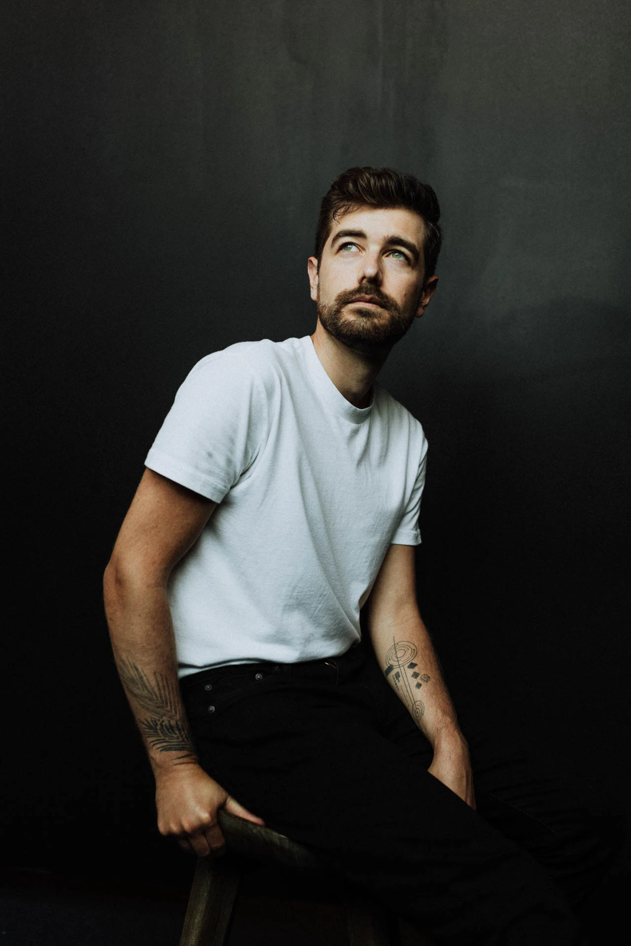 Jonathan Grado on a stool looking up