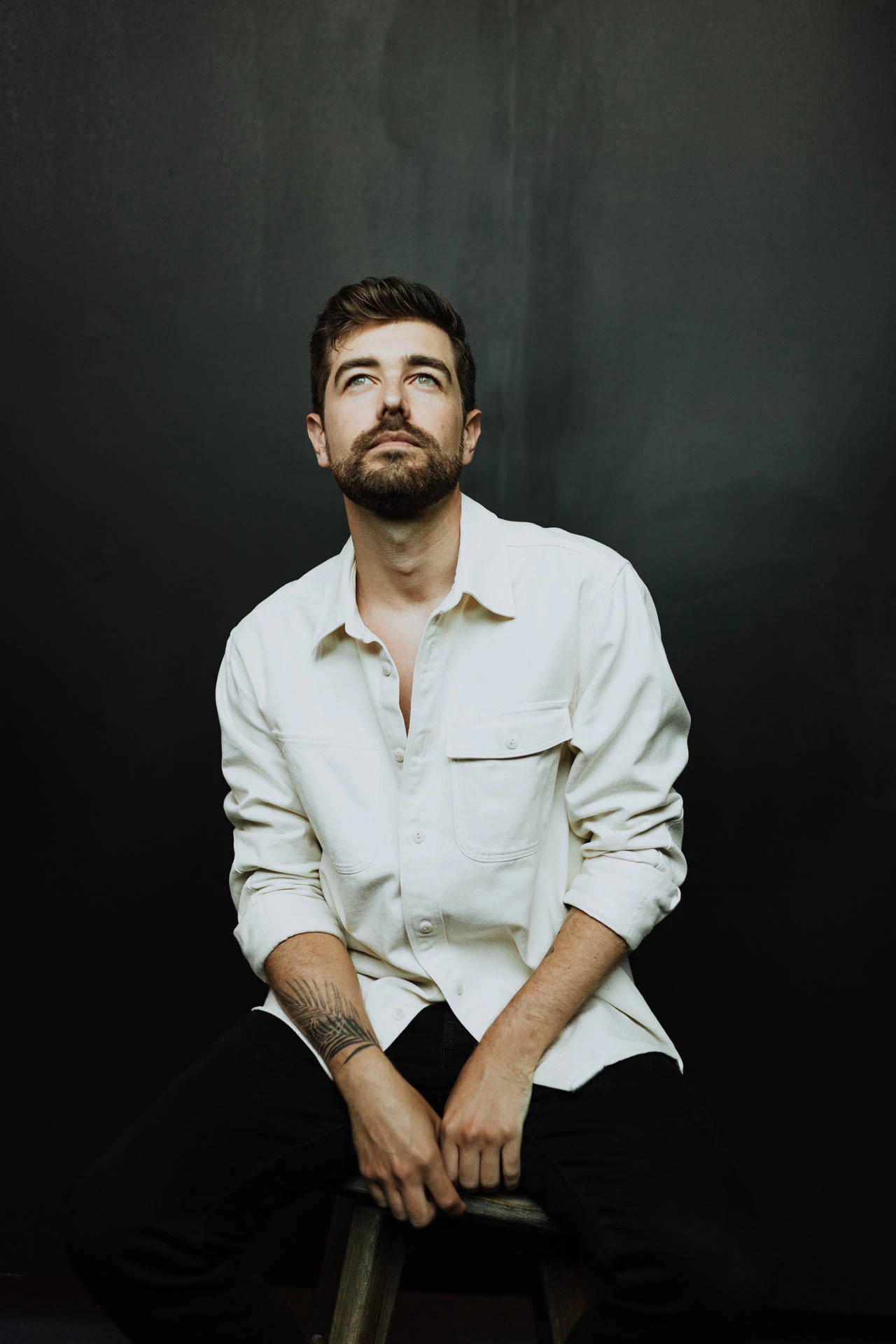 portrait of Jonathan Grado on a stool