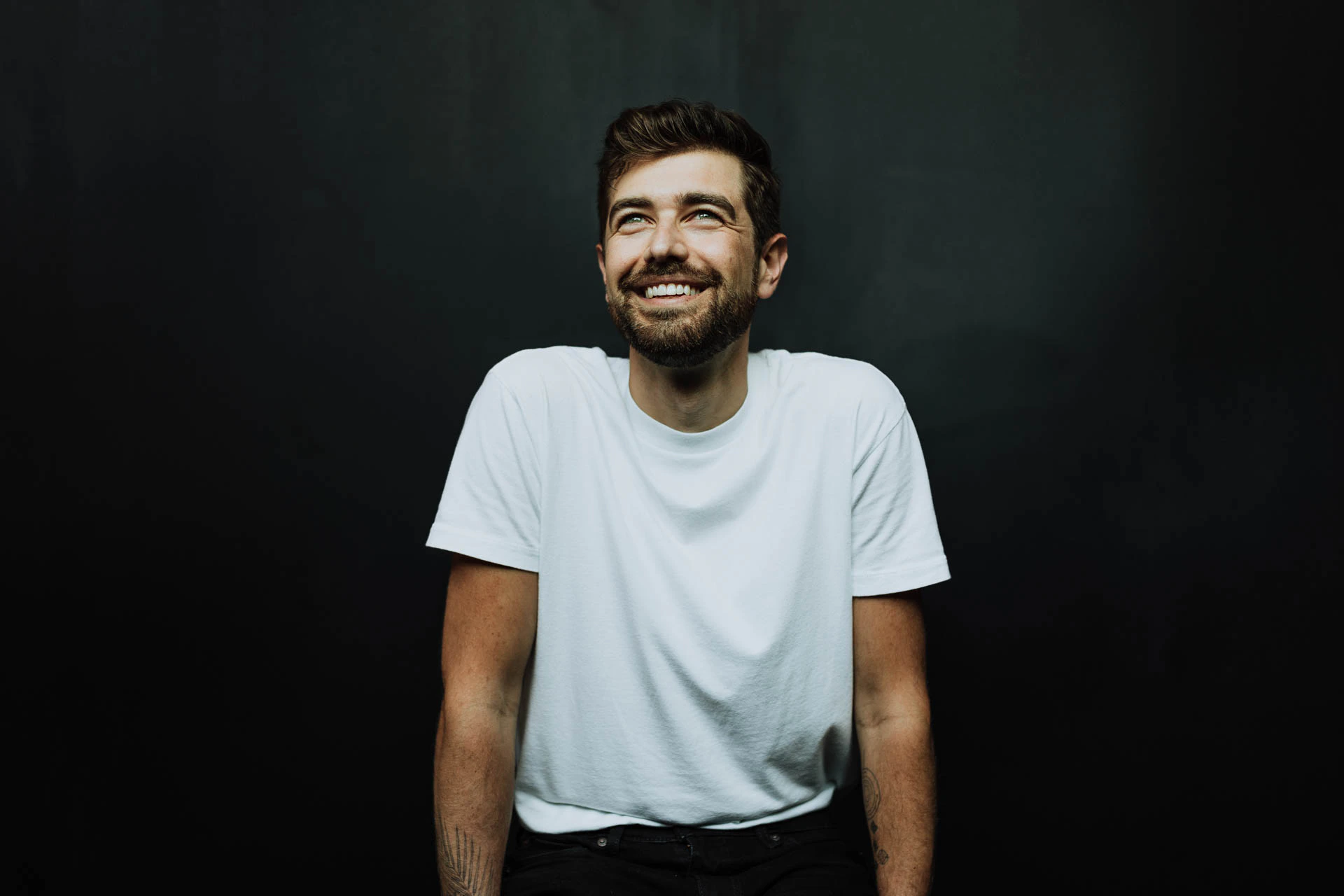 portrait of Jonathan Grado smiling in a white shirt