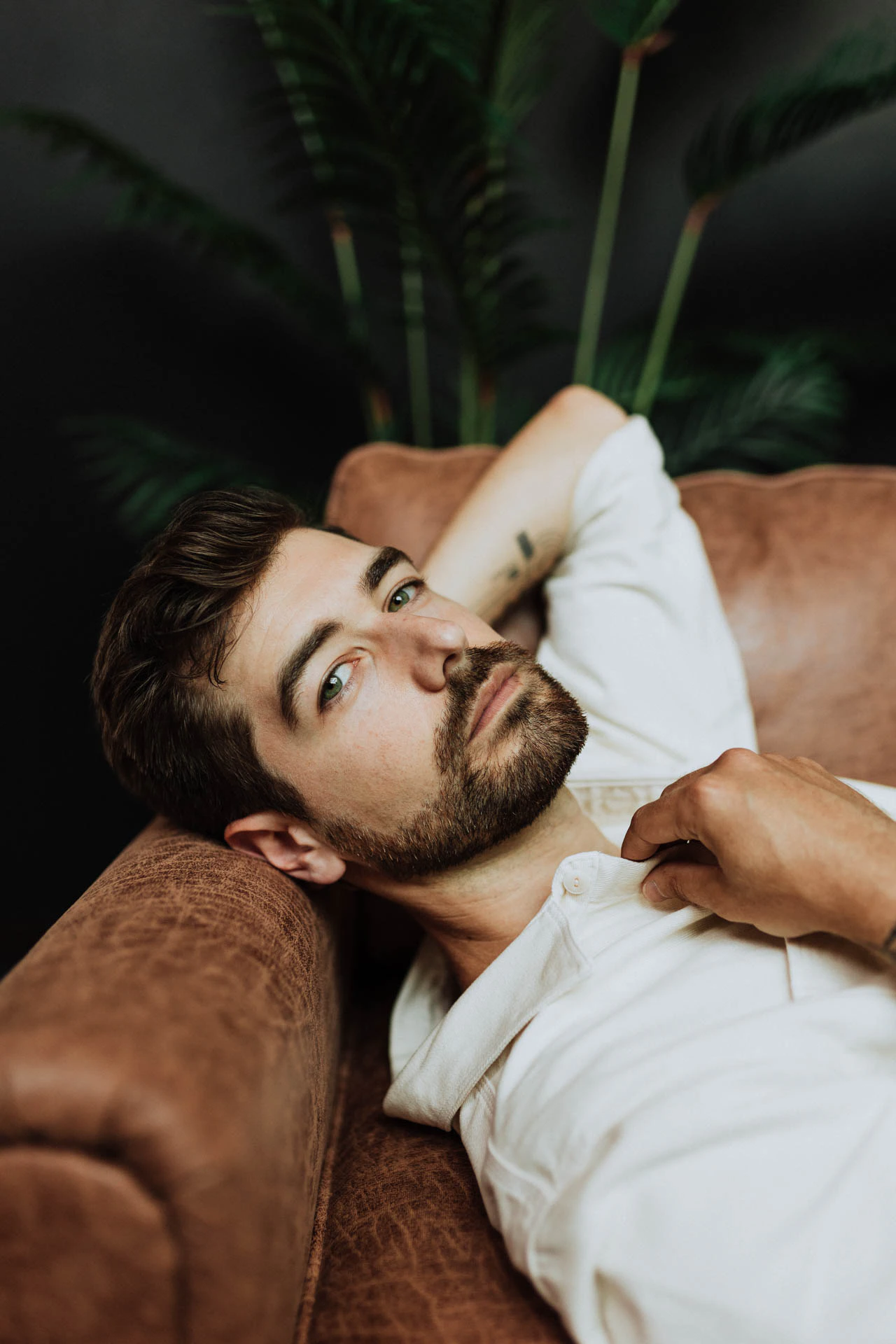 portrait of Jonathan Grado on a leather couch