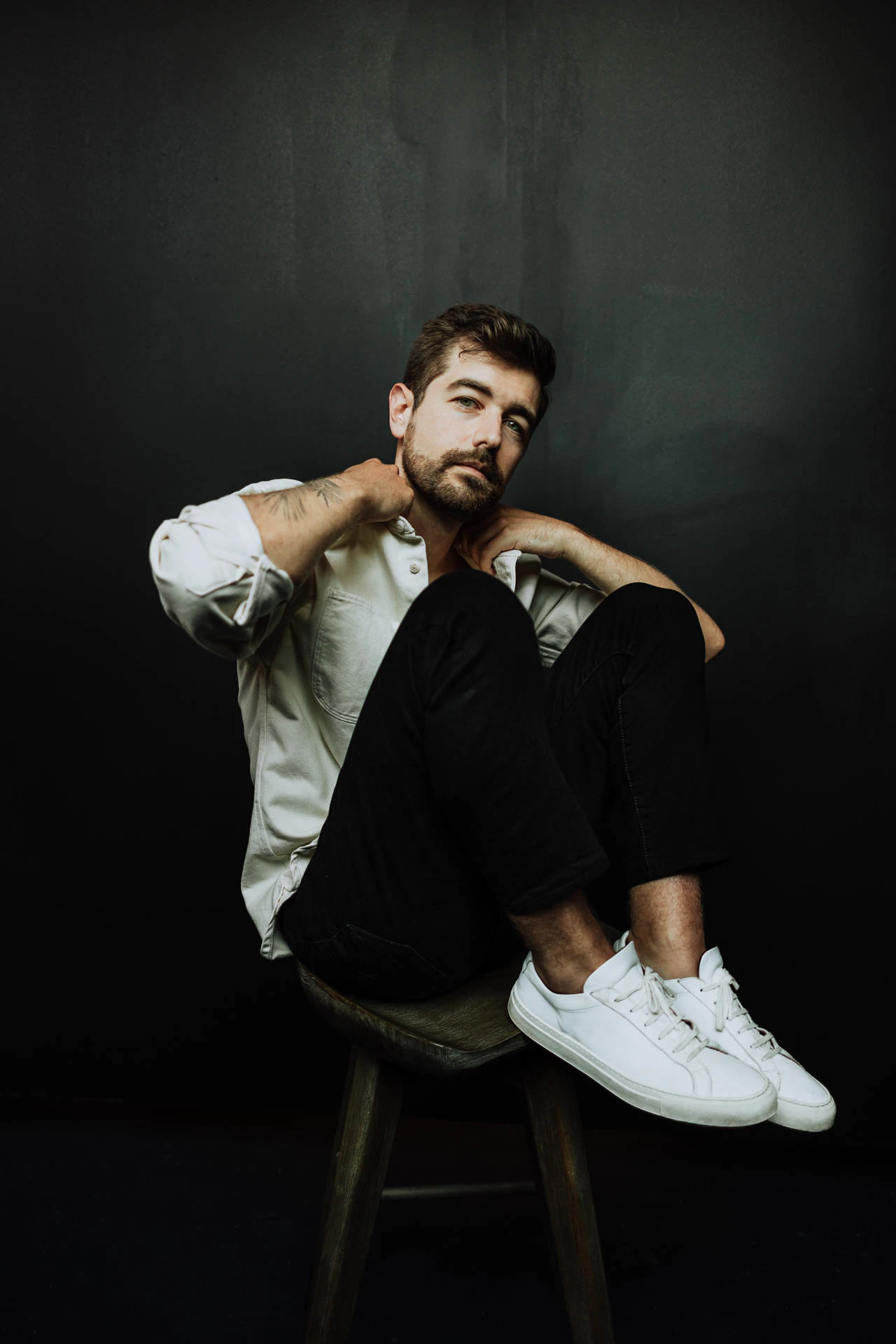 portrait of Jonathan Grado with his feet on a stool