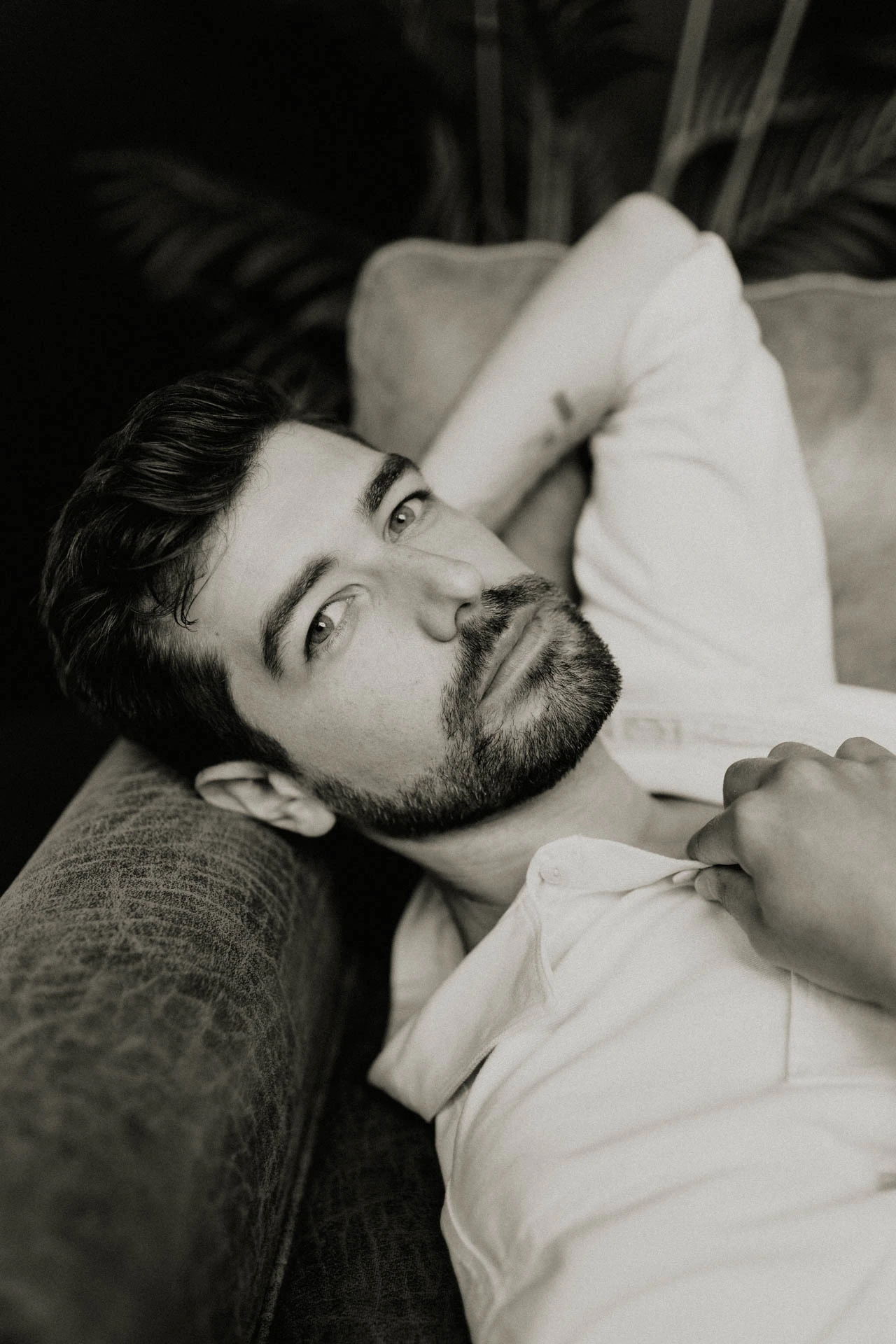 portrait of Jonathan Grado on a leather couch in black and white