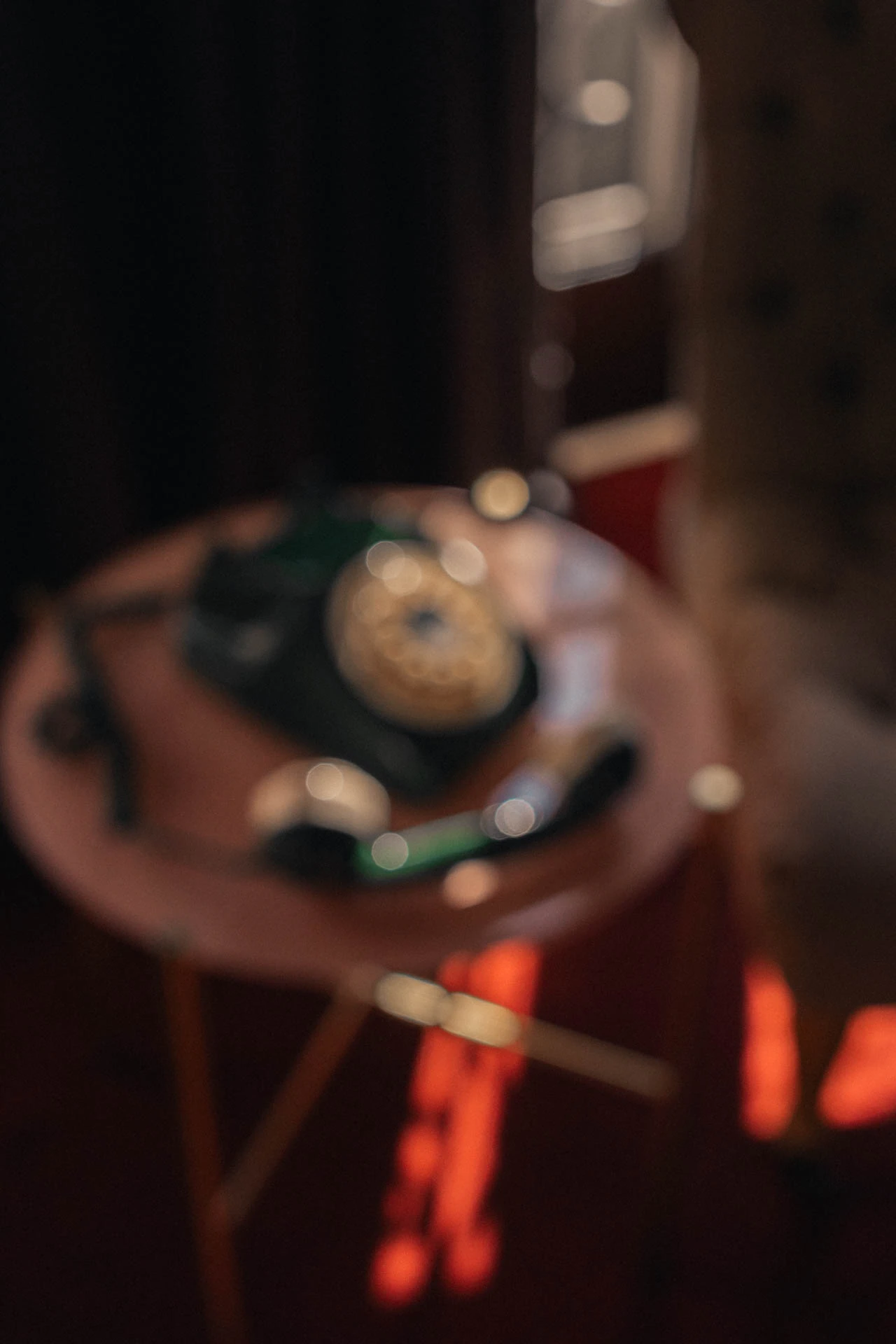 An old green rotary phone with a blue briefcase. An old hotel with red carpet. Sunset.