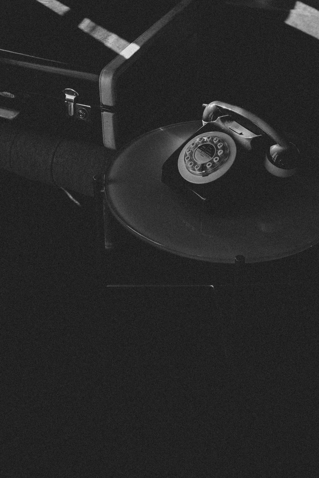 black and white rotary phone and luggage in Santa monica hotel during sunset