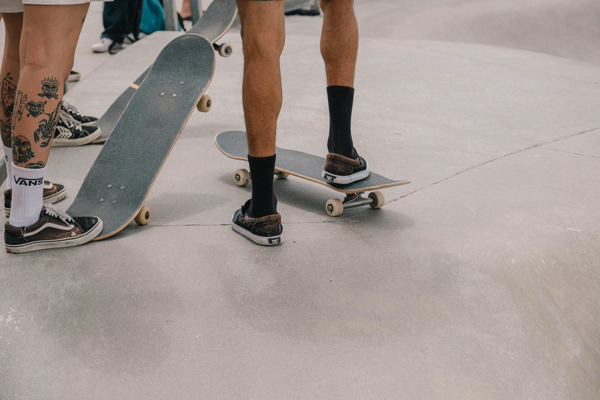skateboarders waiting to drop in at Venice Beach skate park