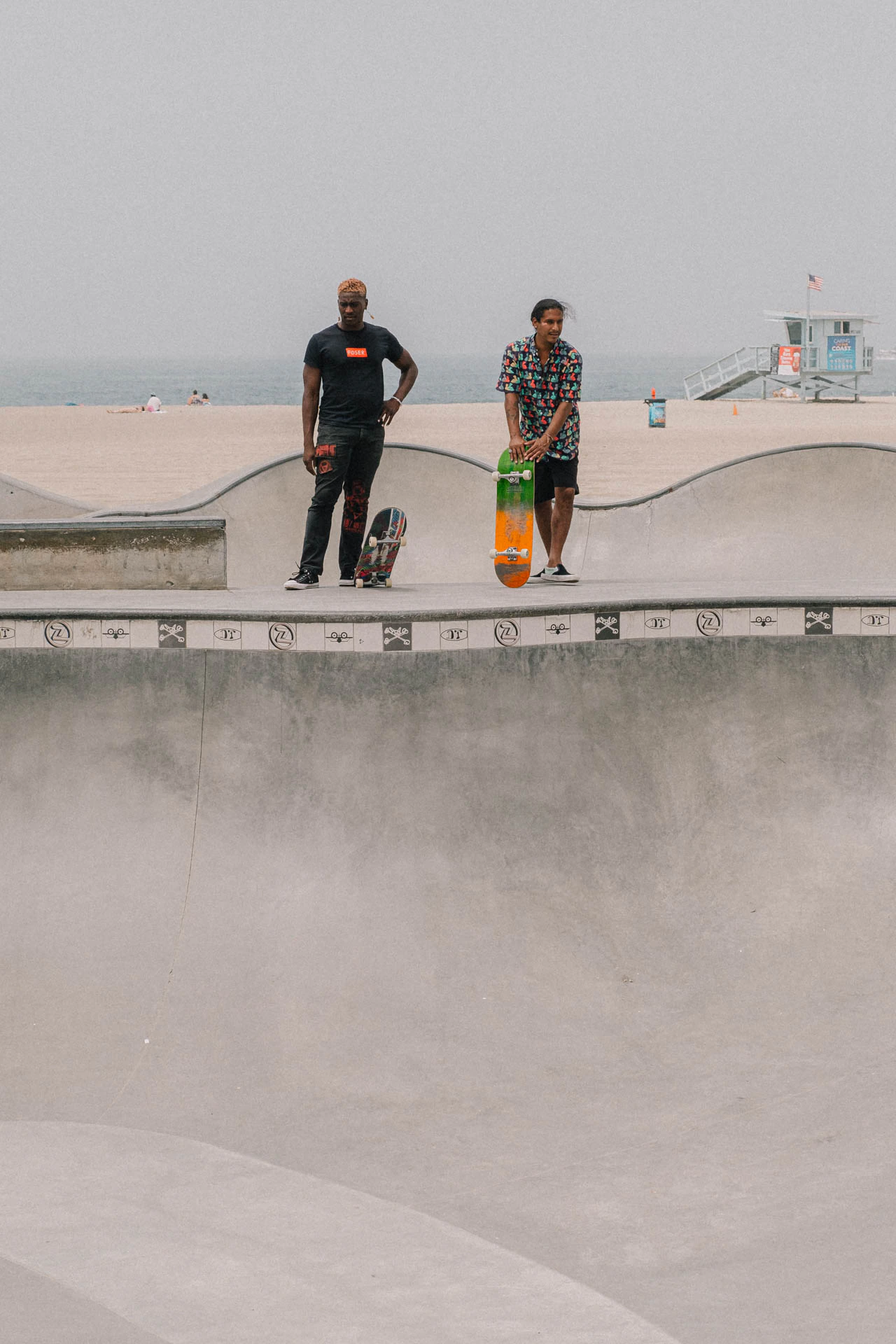 two skateboarders waiting to drop in