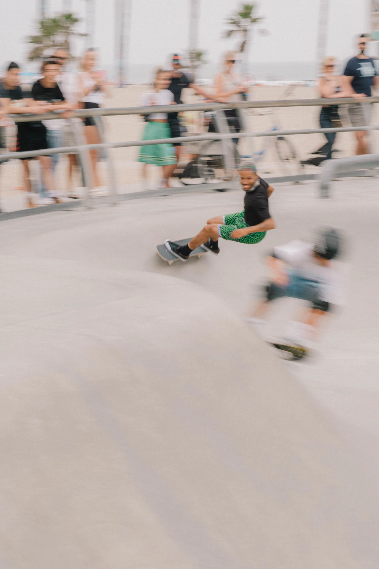 two skateboarders in motion at Venice beach