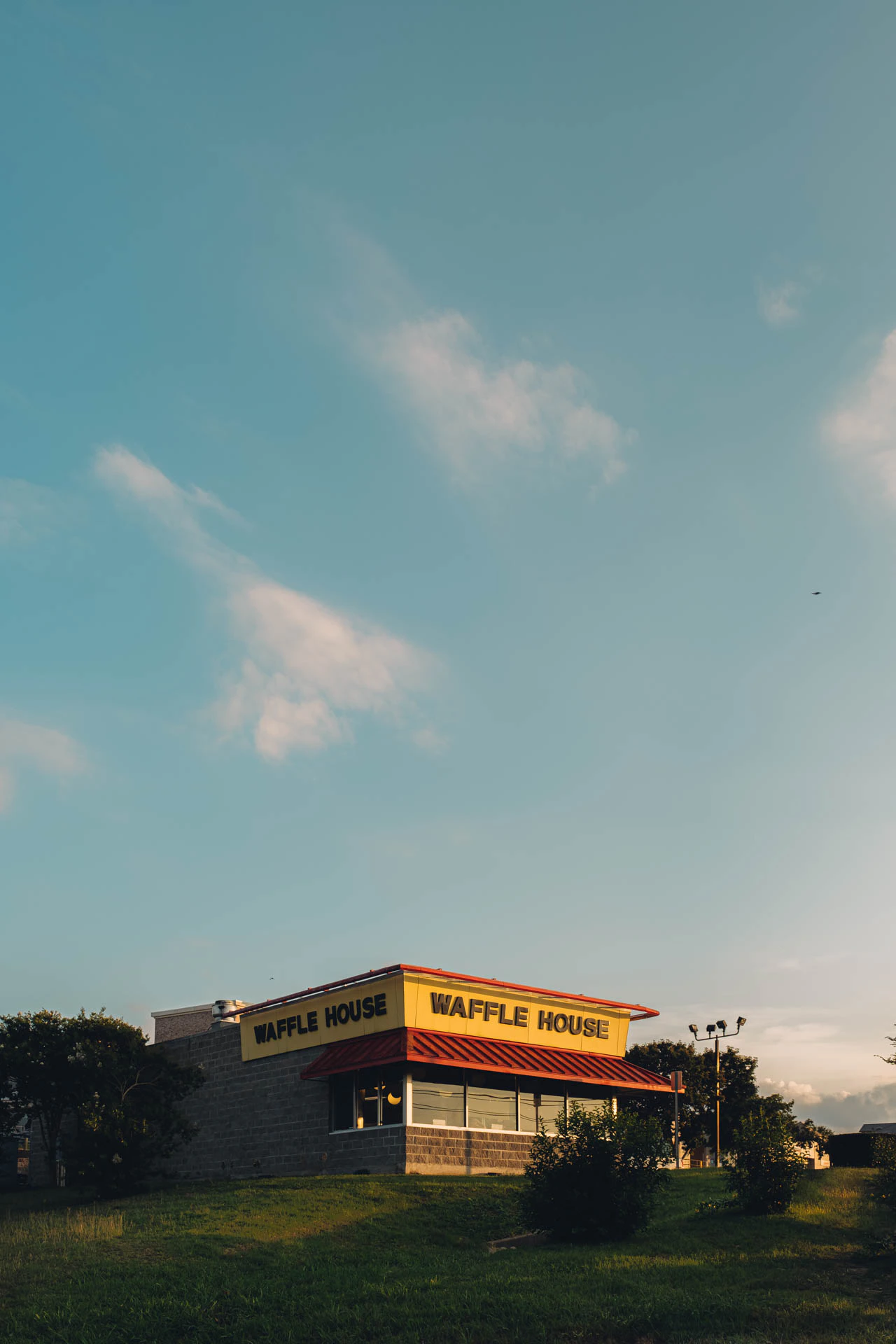 clouds above Waffle House at Sunset on a grassy hill in Texas