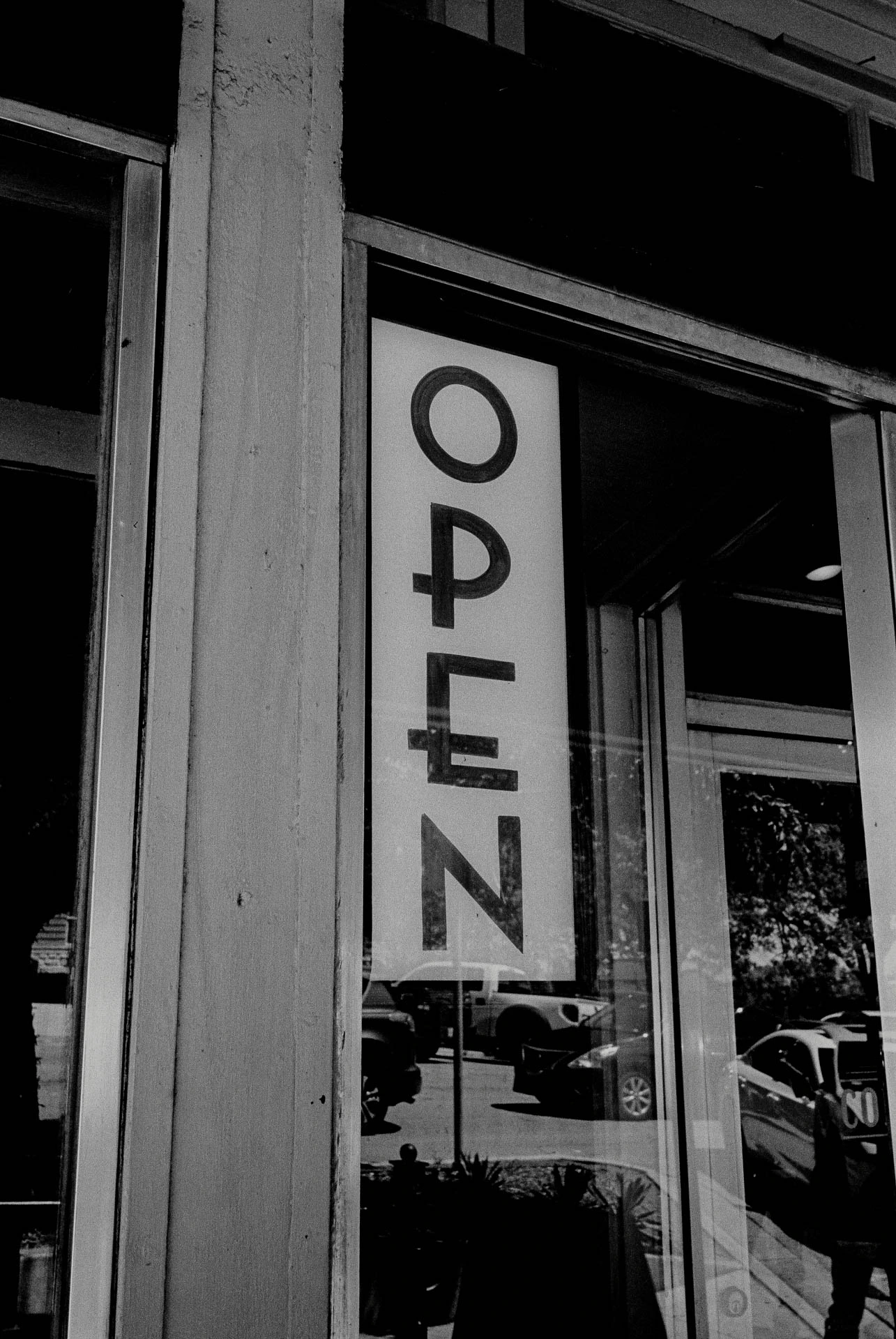Open sign on black and white film in San Marcos