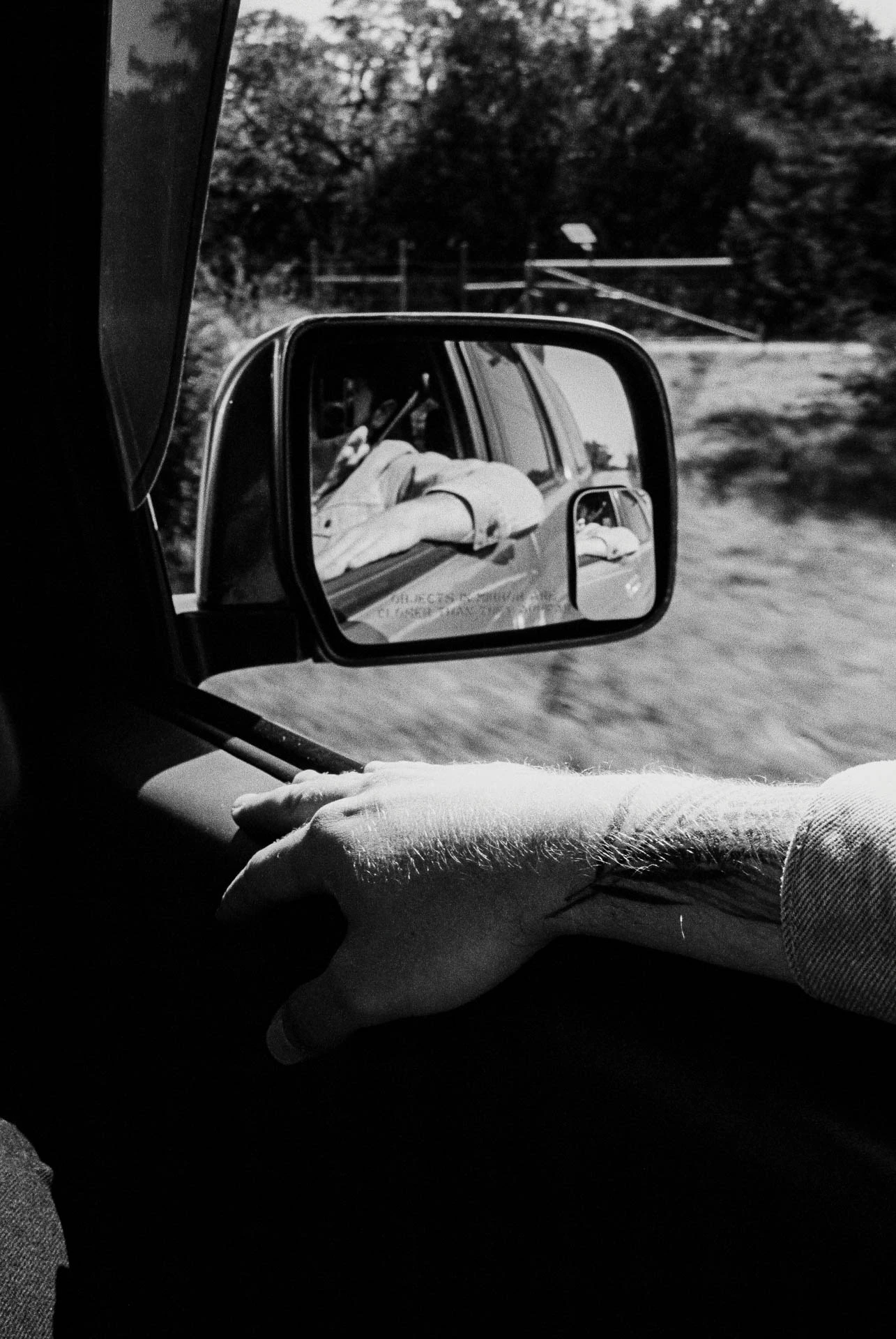 side view mirror and arm on black and white film in Texas