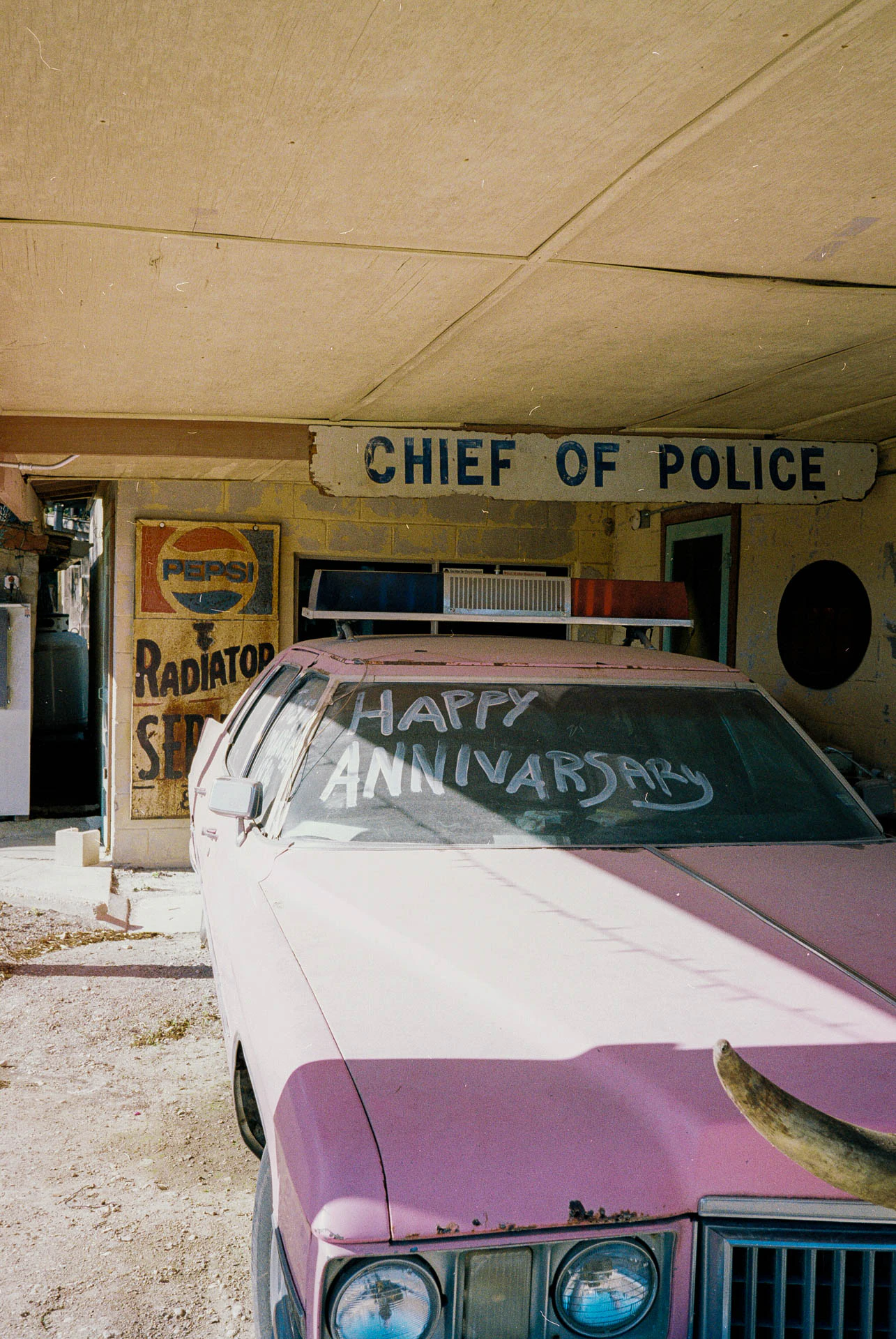 pink car reading happy anniversary at devils backbone in texas on film