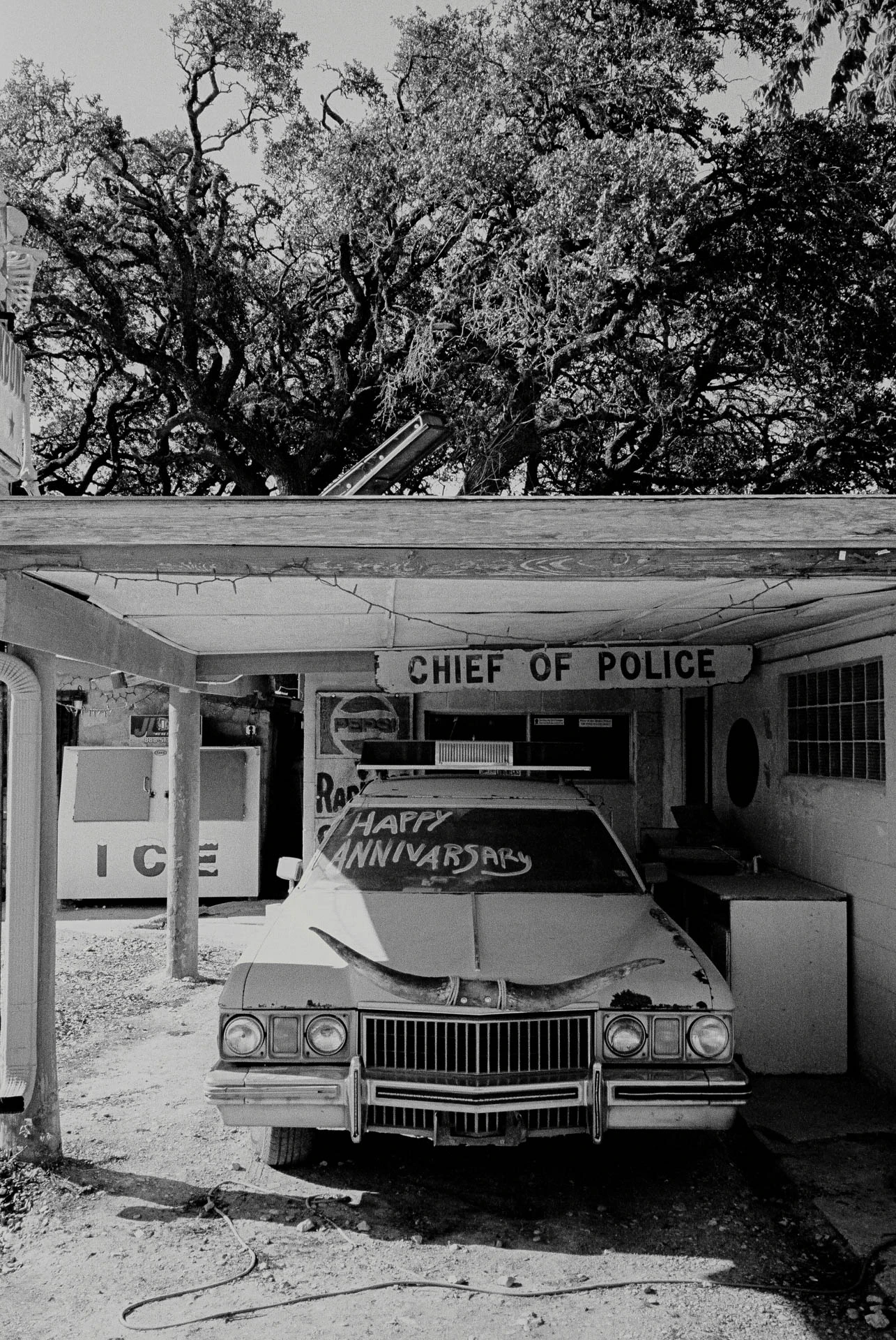 pink car reading happy anniversary at devils backbone in texas on black and white film.