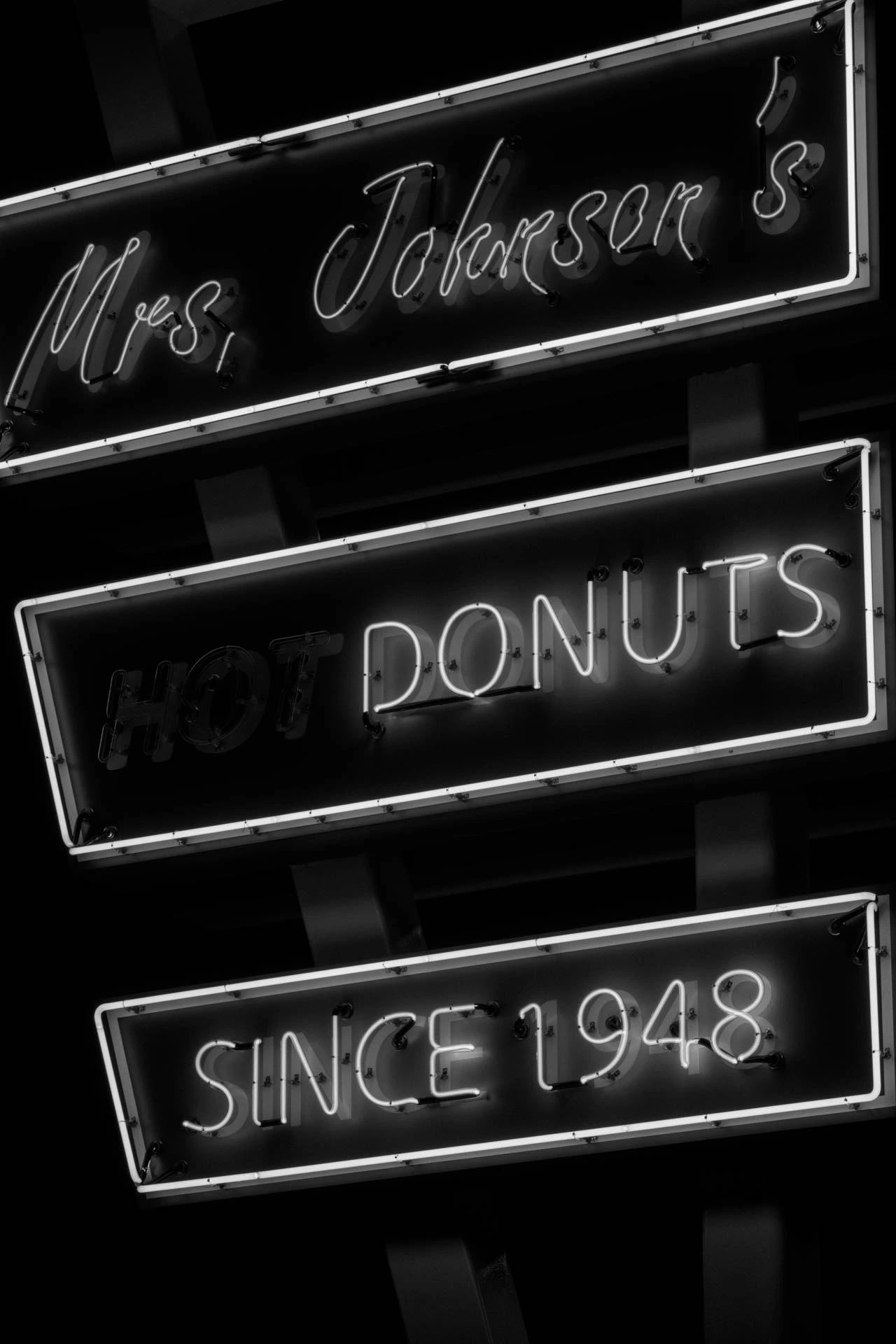 mrs Johnsons hot donuts neon sign in Austin Texas at night